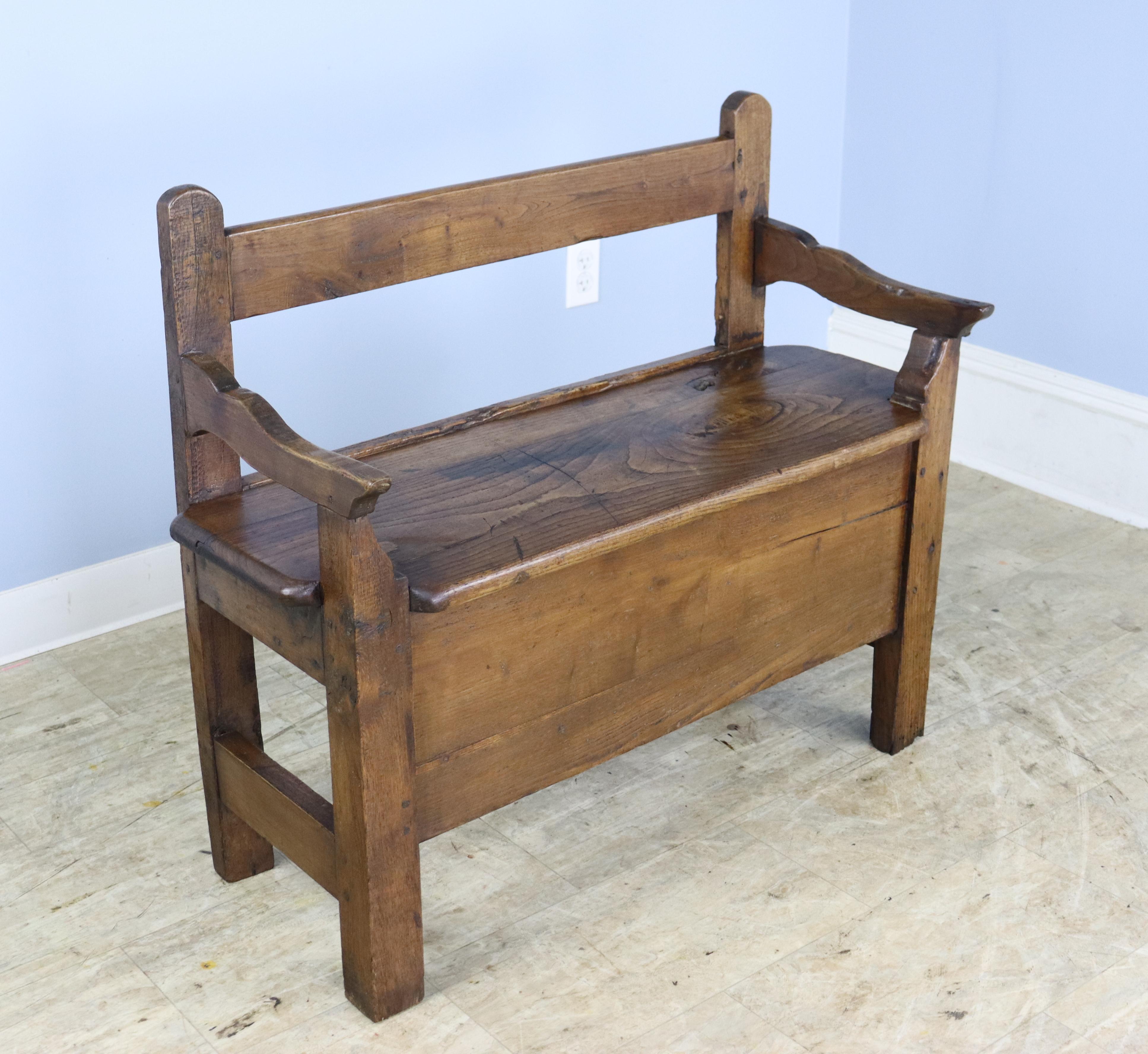 A sweet chestnut bench in glossy chestnut.  Very good grain and patina.  Would be right in the hallway, at the end of a bed, or in the mudroom.  seat does not flip up.