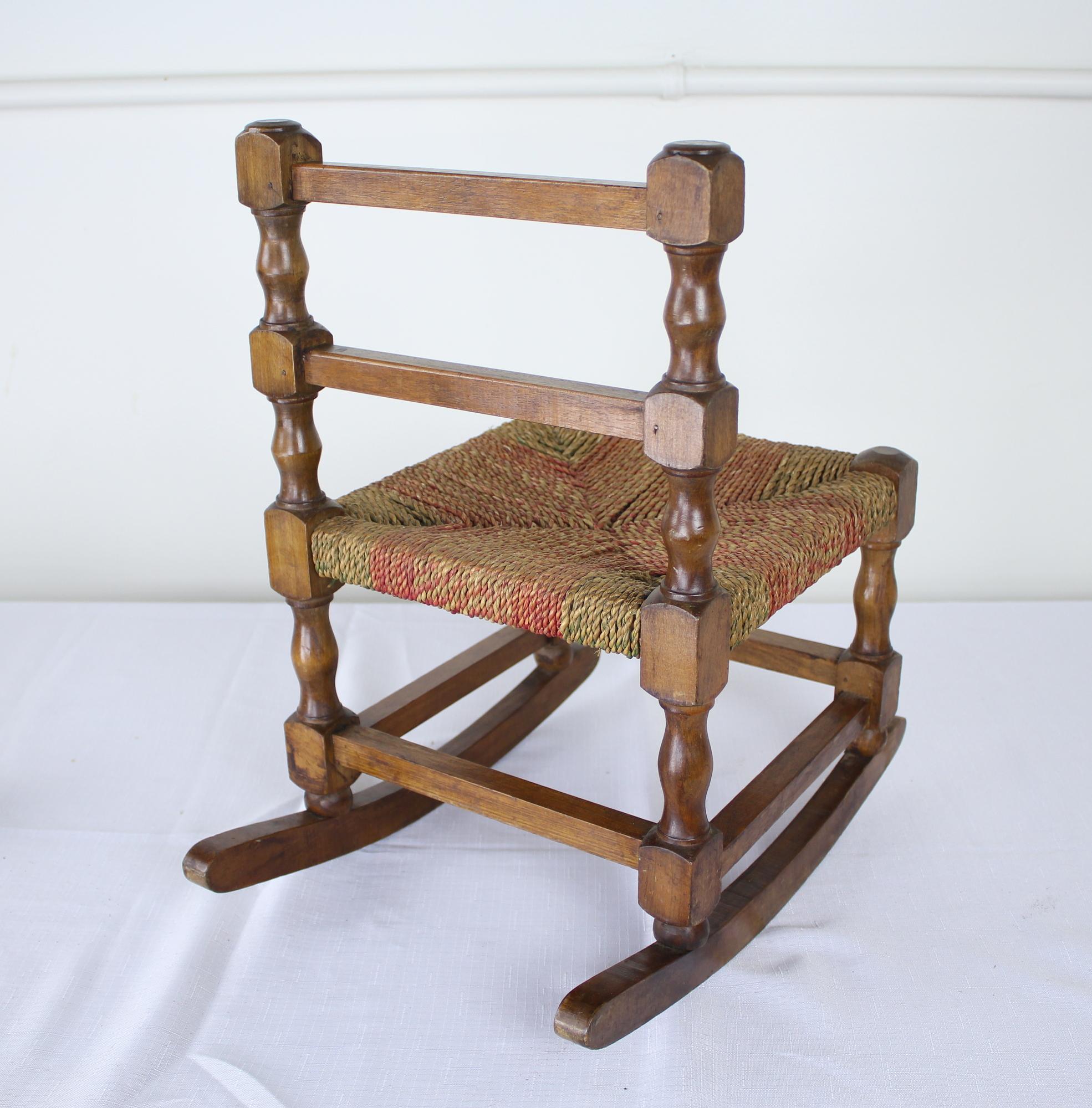 A tiny sweet perch for a tiny person! The string on this piece is in very good antique condition, strong enough to be sat or stood upon. The oak has rich color and nice finish. A soon-to-be family heirloom!