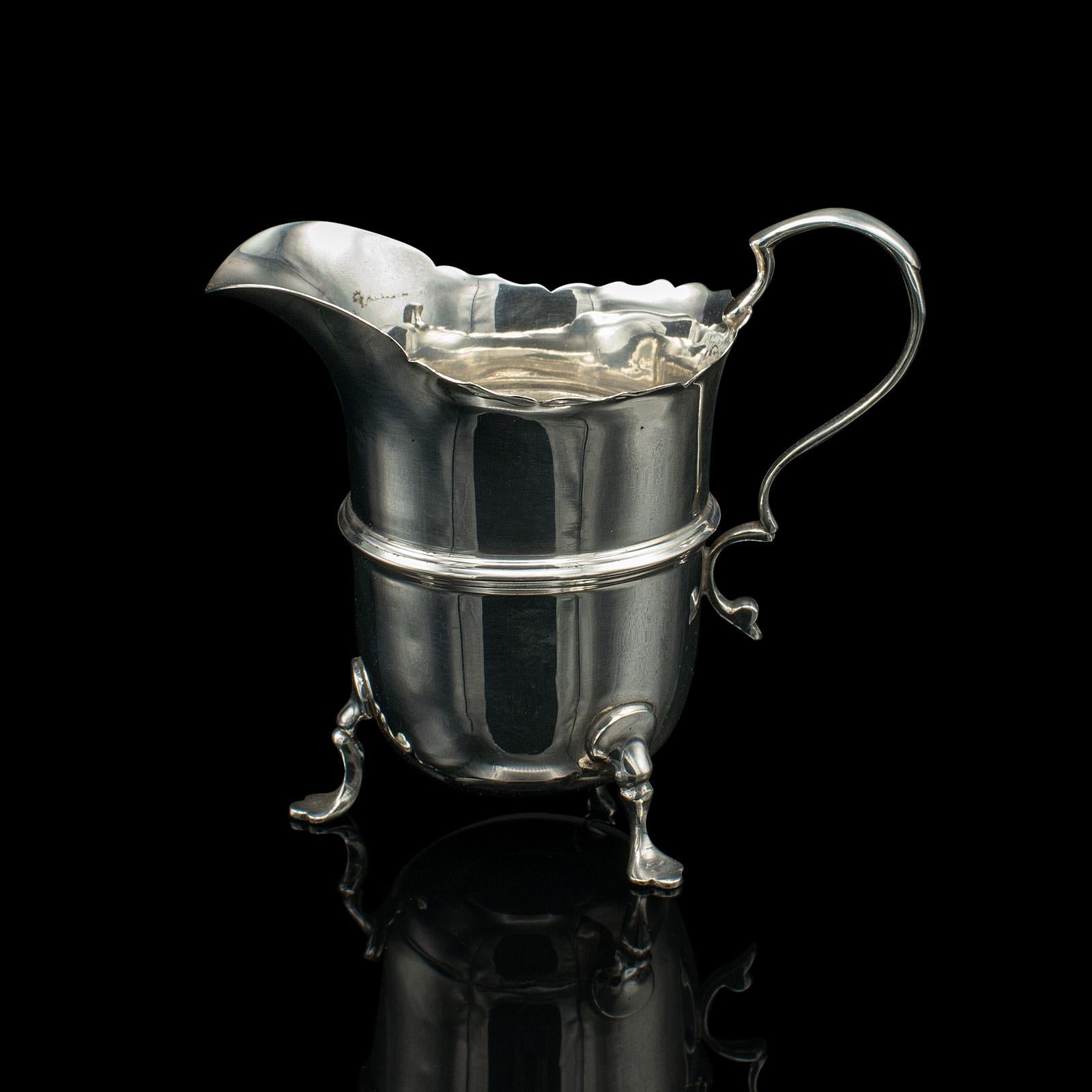 This is a small antique cream jug. An English, sterling silver milk pourer, dating to the early 20th century, hallmarked 1919.

Darling breakfast table pourer, with a superb reflective quality
Displays a desirable aged patina and in good original