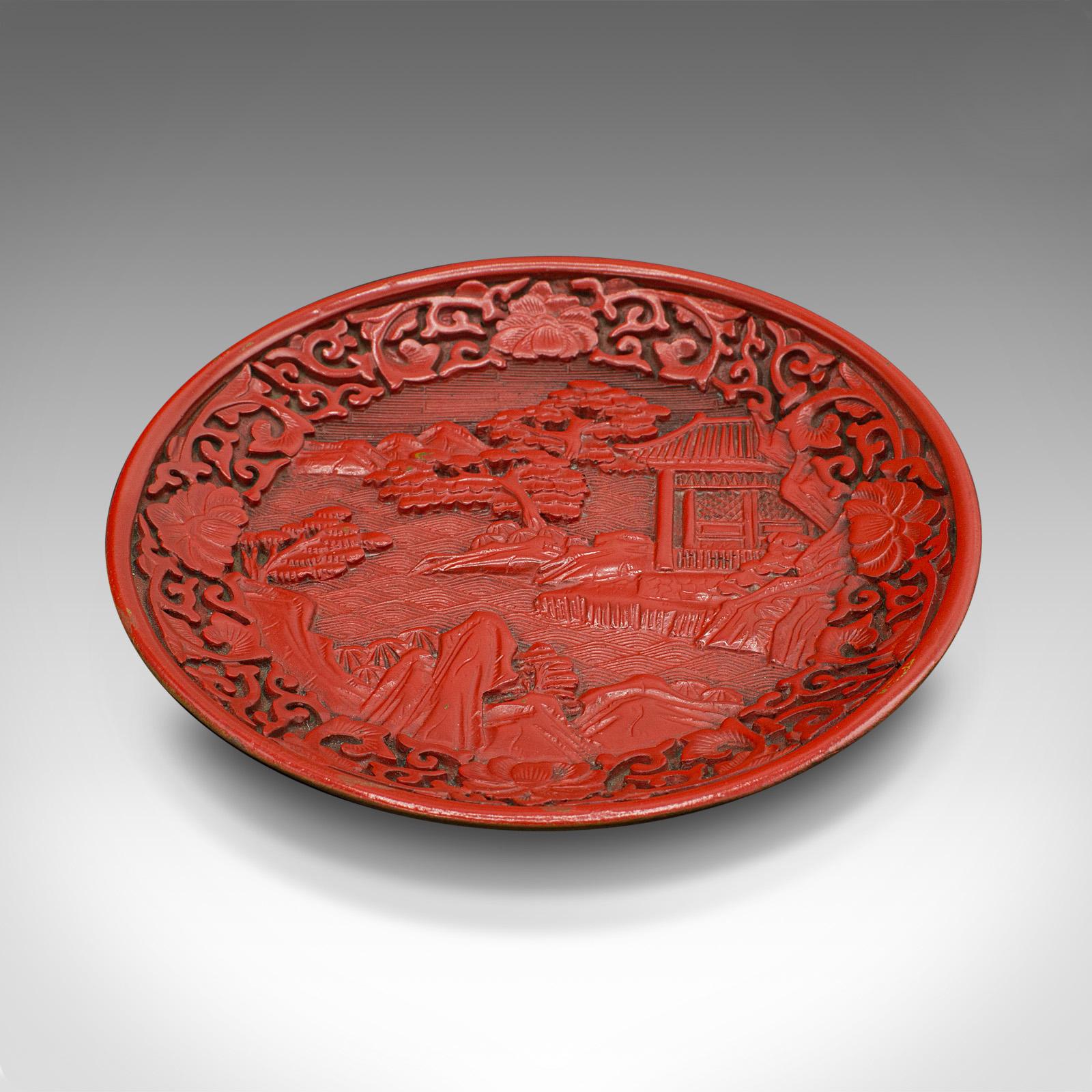 This is a small antique decorative Cinnabar dish. A Chinese, red lacquer display plate, dating to the Qing dynasty, circa 1900.

Striking example of the distinctive Chinese decorative art.
Displays a desirable aged patina - in very good order.
A
