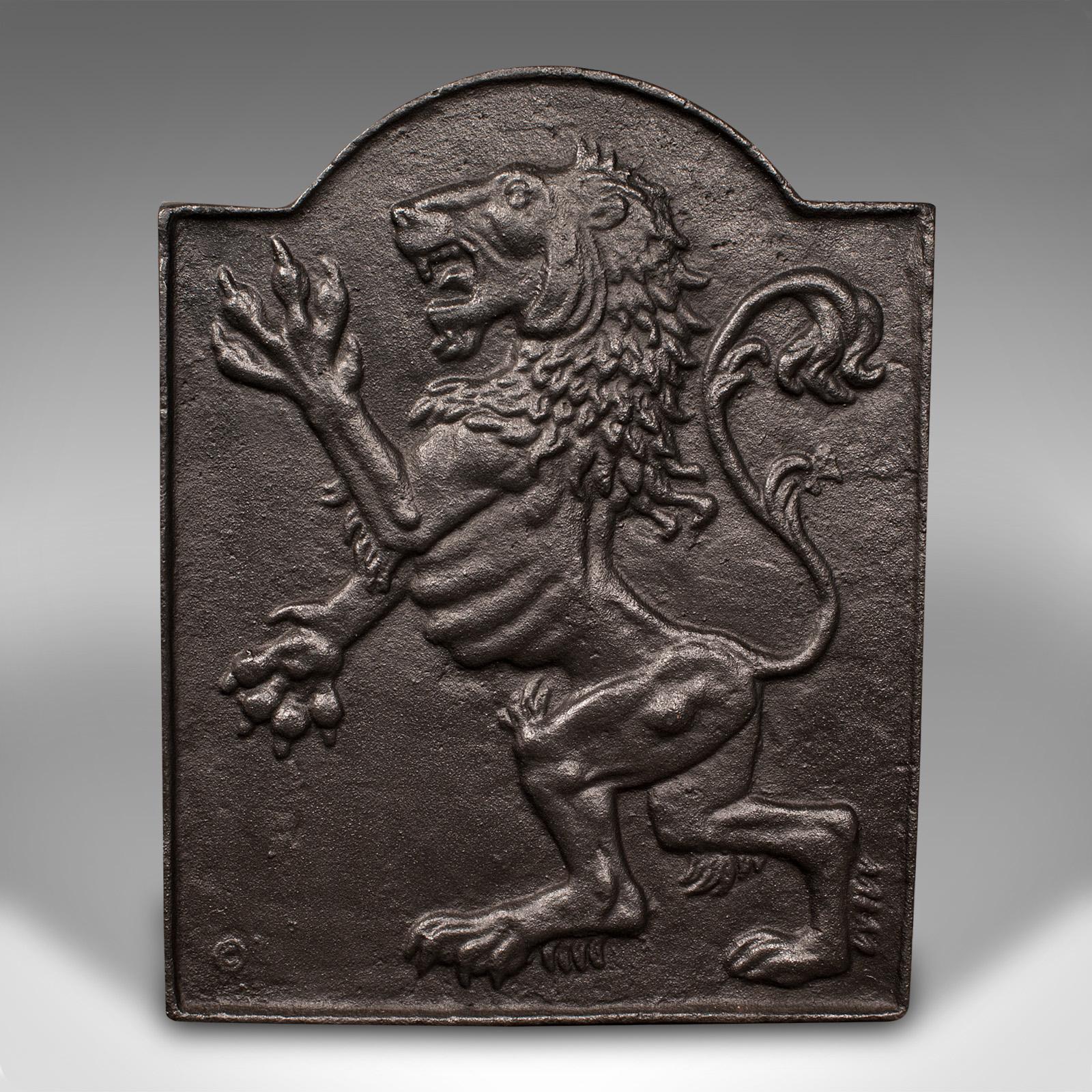This is a small antique decorative fire back. An English, cast iron fireplace reflector with Lion Rampant relief, dating to the late Victorian period, circa 1900.

Appealing heraldic motif to this smaller fire back
Displays a desirable aged patina