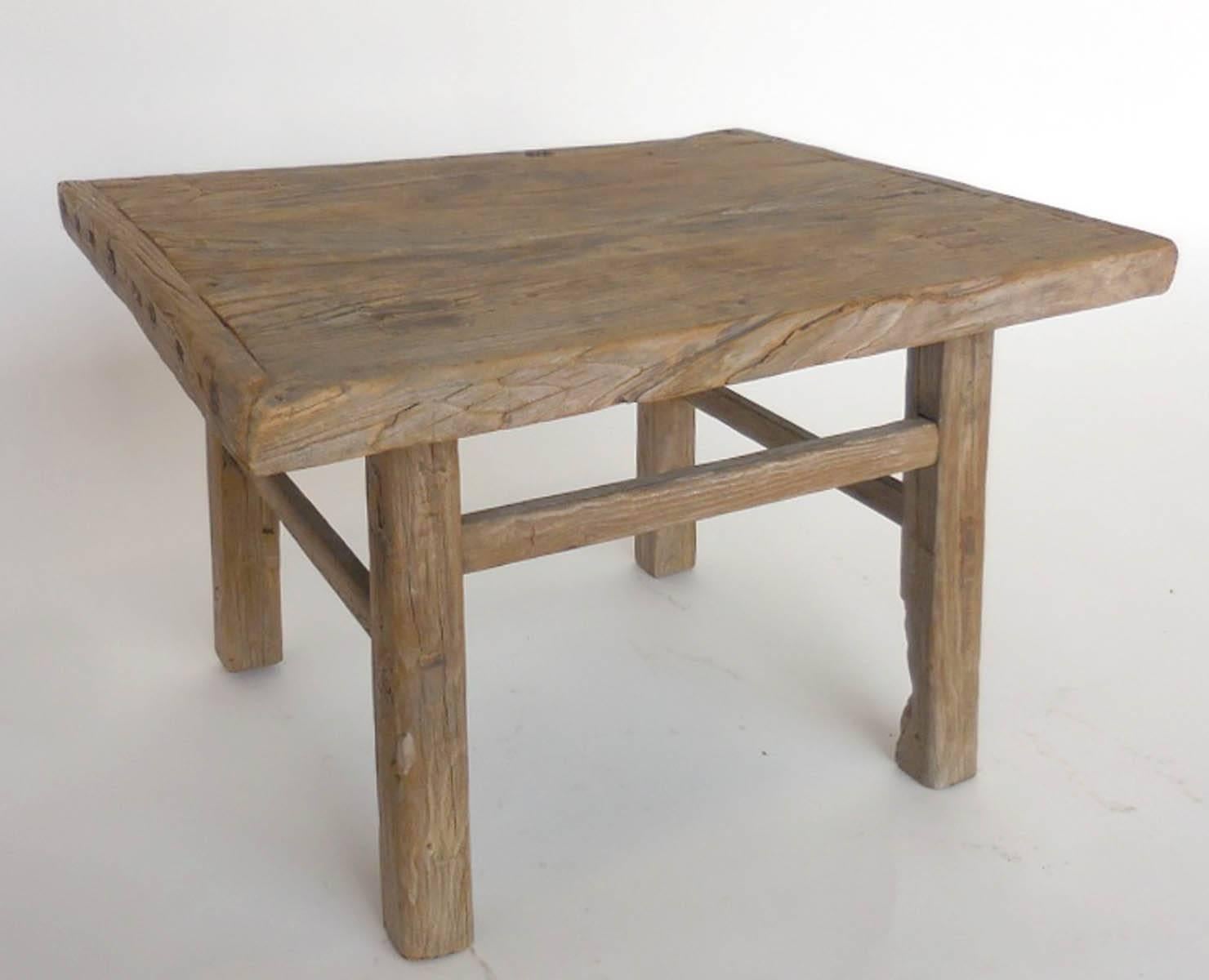 Small rectangular antique elm table from China. Mortise and tenon construction. Weathered wood with naturally worn patina.