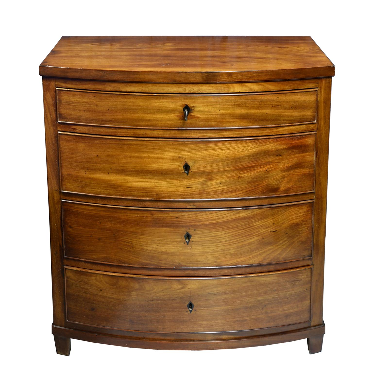 An unusually small bowed-front Empire chest in fine West Indies Mahogany with four drawers with inlaid ebony key plates. Chest rests on tapered square feet, Denmark, circa 1810. Makes a stunning hall table, end table or nightstand!

Measures: 28