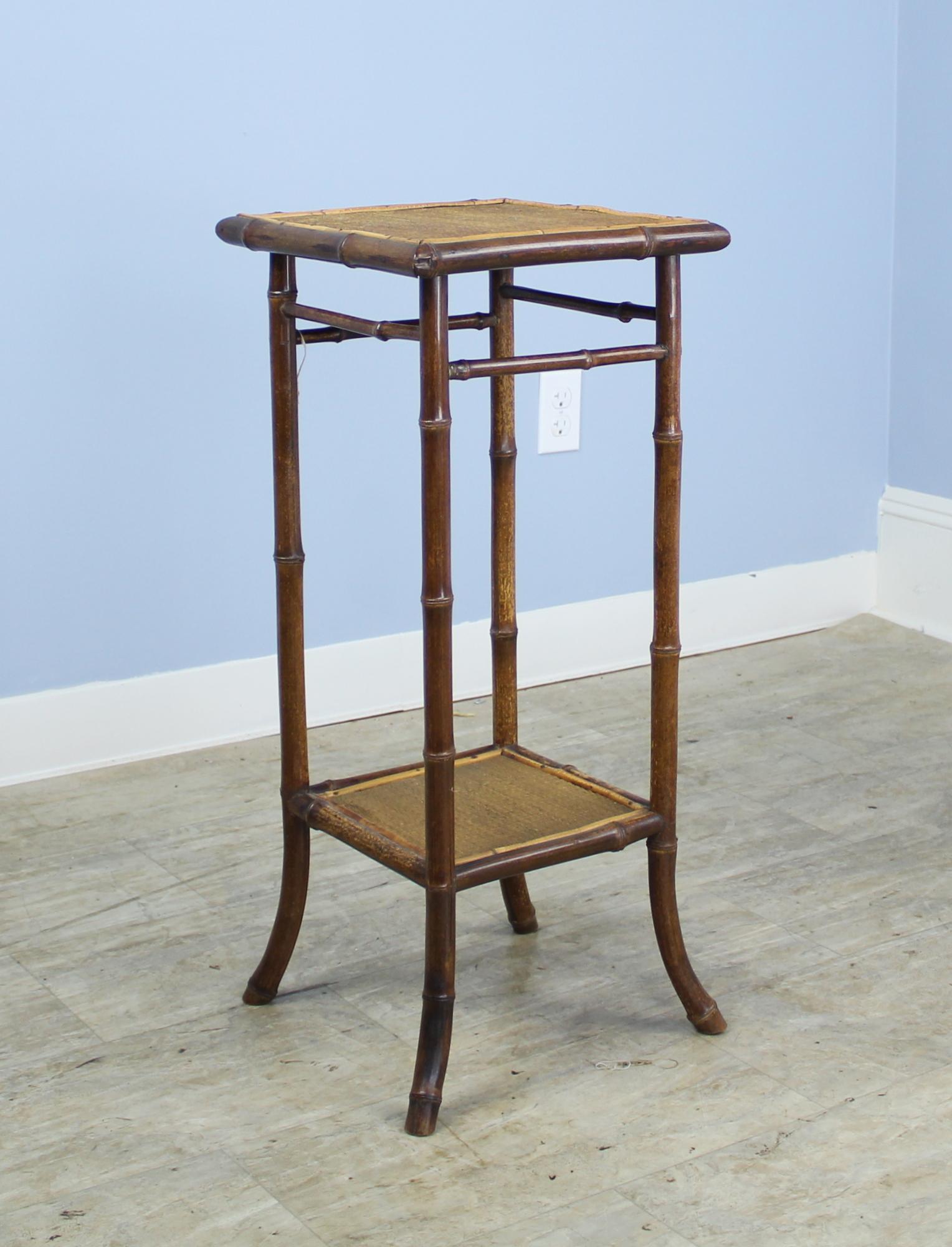 A small bamboo side table, with wonderful antique dark color and patina. The flared painted legs still retain their vibrancy. Sweet!