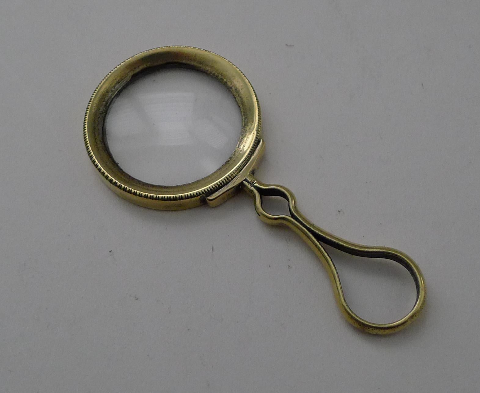 A small antique English magnifying glass with a polished brass handle and frame.  The glass has a good magnification and remains in undamaged condition.

Dating to c.1900, it remains in excellent condition measuring 2 7/8