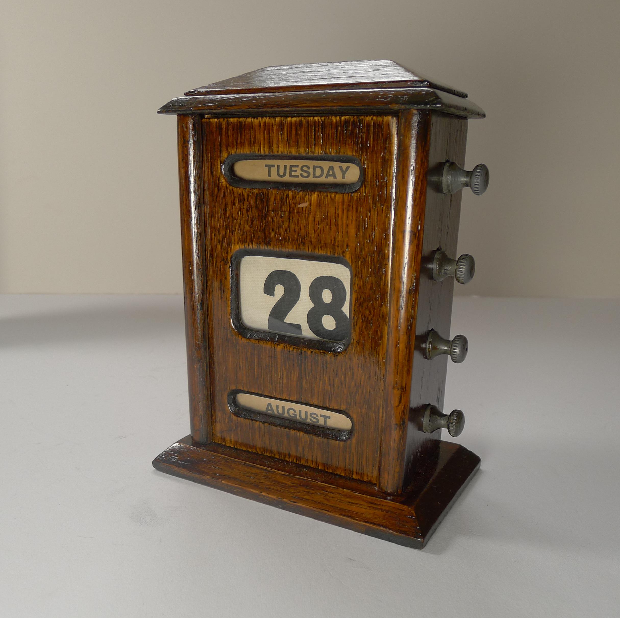 A handsome desk-top wooden perpetual calendar made from solid English.

The metal keys to the sides are used to forward and return the day, date and month rolls behind the glazed apertures.

Dating to the Edwardian era, c.1900 it remains in