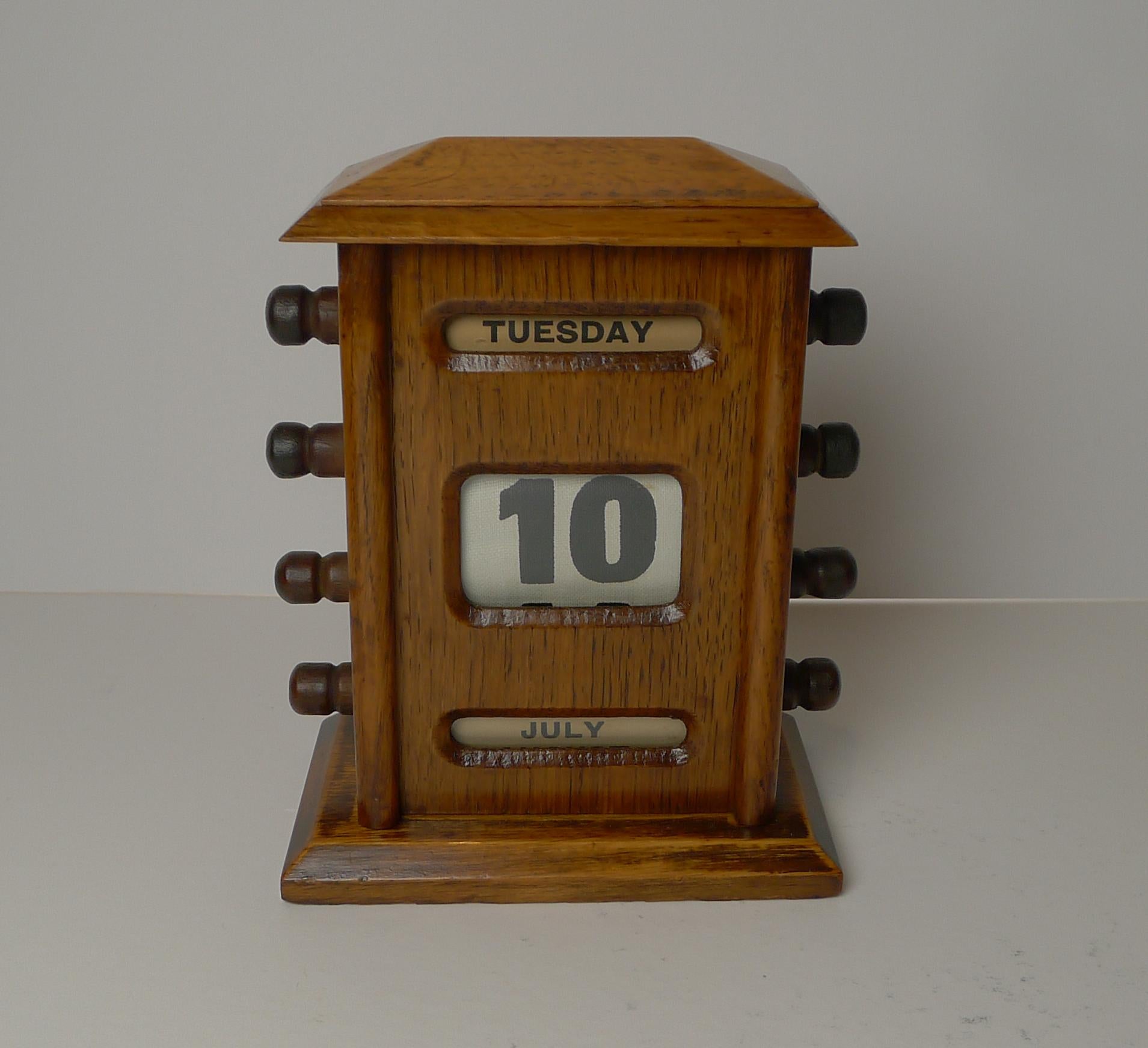 A handsome desk-top wooden perpetual calendar made from solid English.

The metal keys to the sides are used to forward and return the day, date and month rolls behind the glazed apertures.

Dating to the Edwardian era, c.1900 it remains in