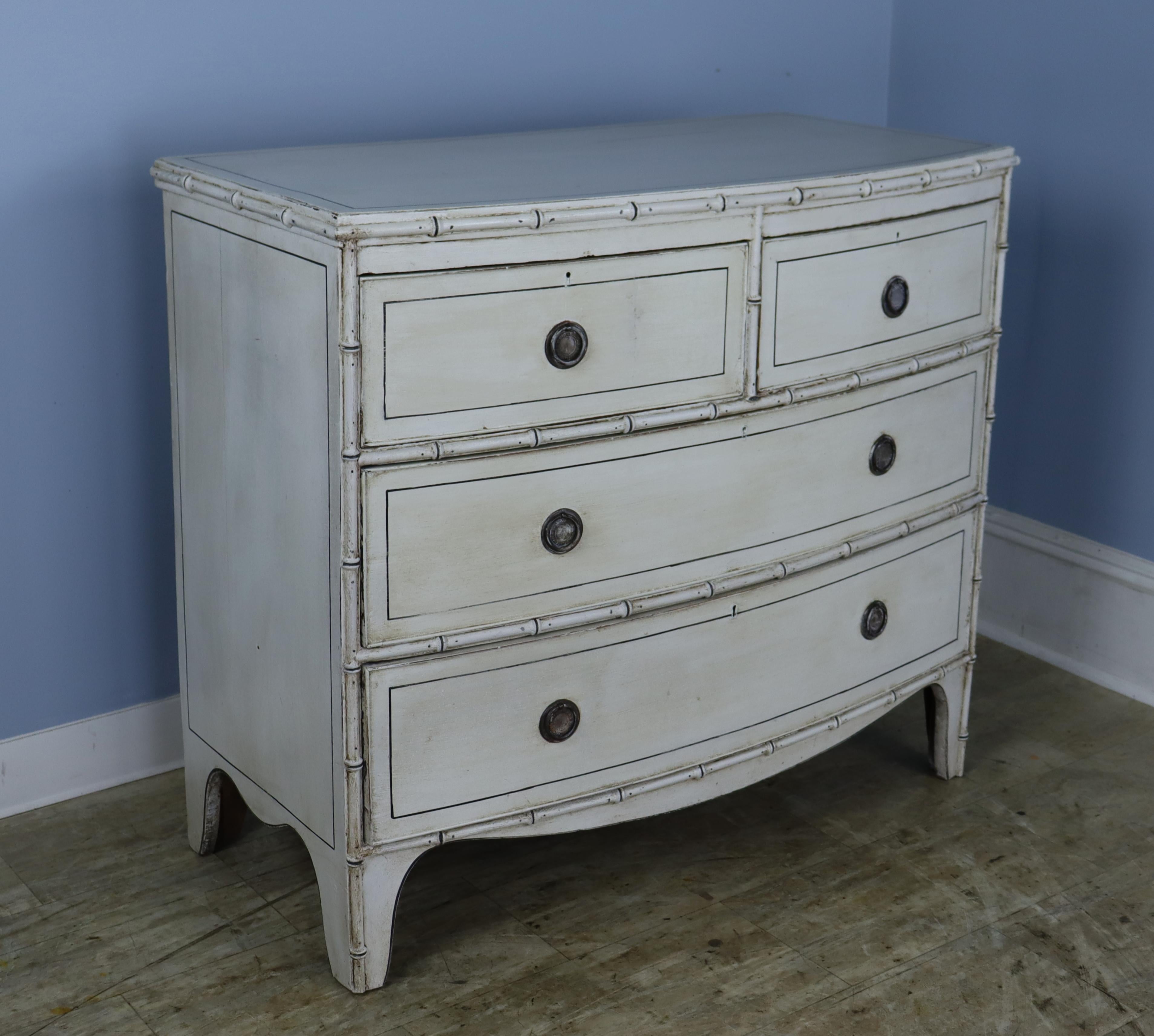 A small English chest of drawers with good faux bamboo detail and mouldings.  The old paint has been refreshed and faux distressed with dark wax.  The shading provided by the wax is hard to convey in photographs and we hope we have done it