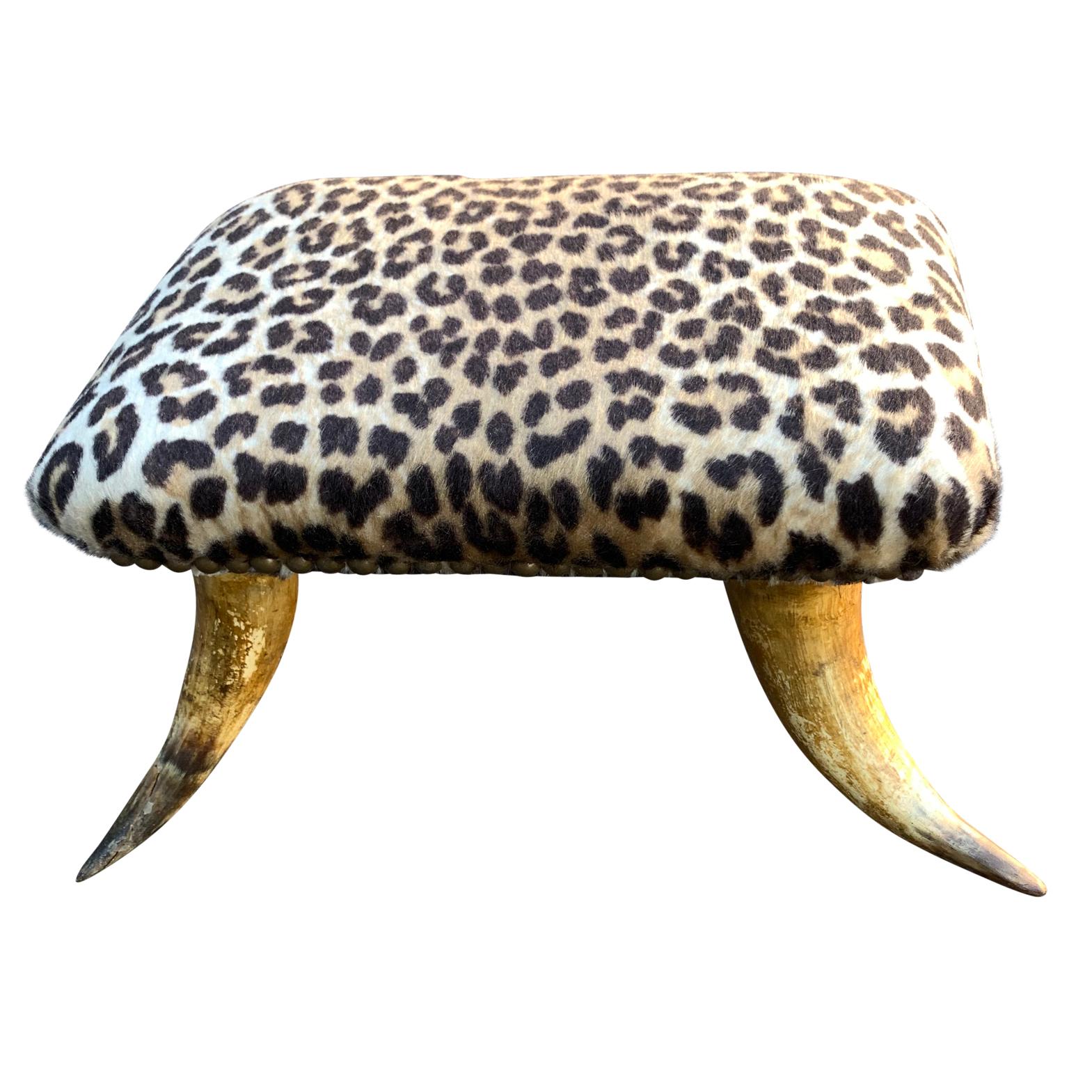Small antique faux cheetah hide upholstered horn footstool.