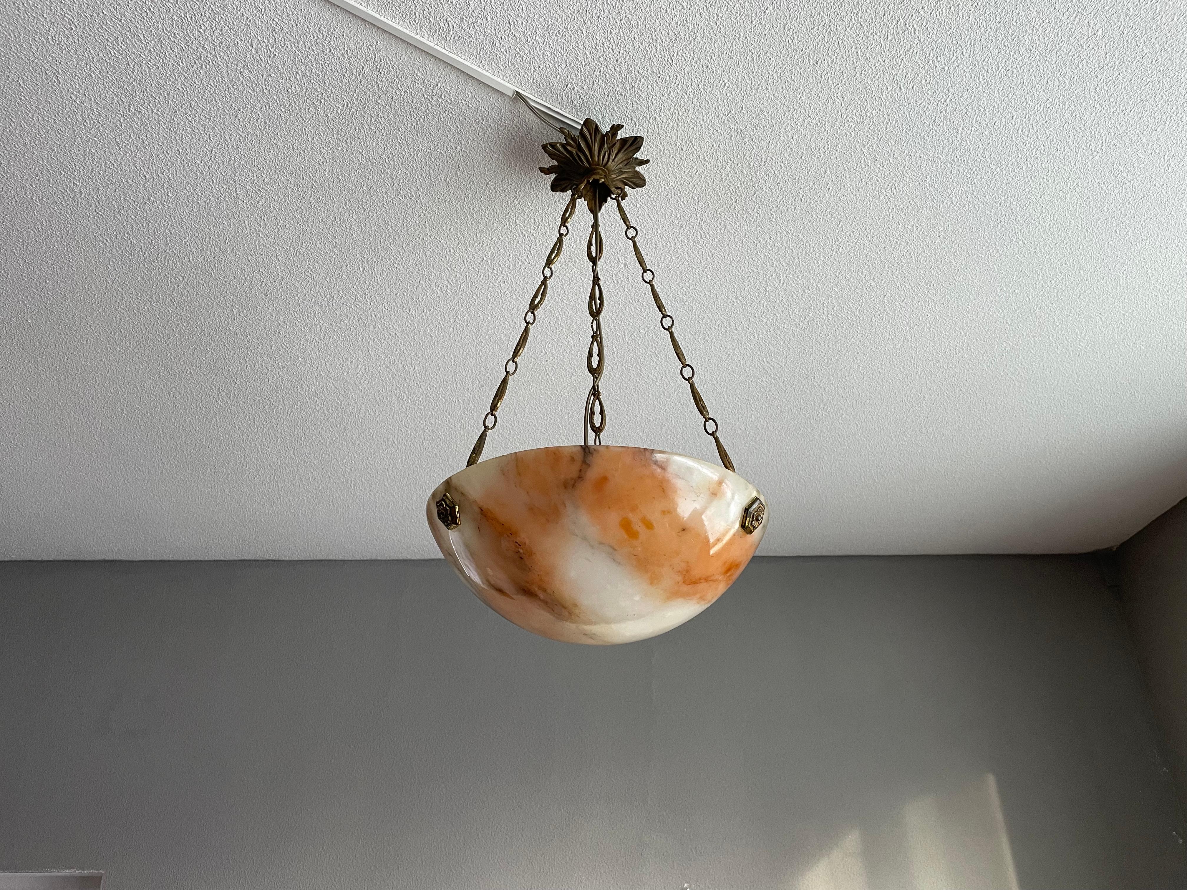 Stylish design & very good condition alabaster light fixture.

If you are looking for a small and stylish antique light fixture then this alabaster and bronze pendant could be just perfect for you. The three gilt brass rosettes at the suspension