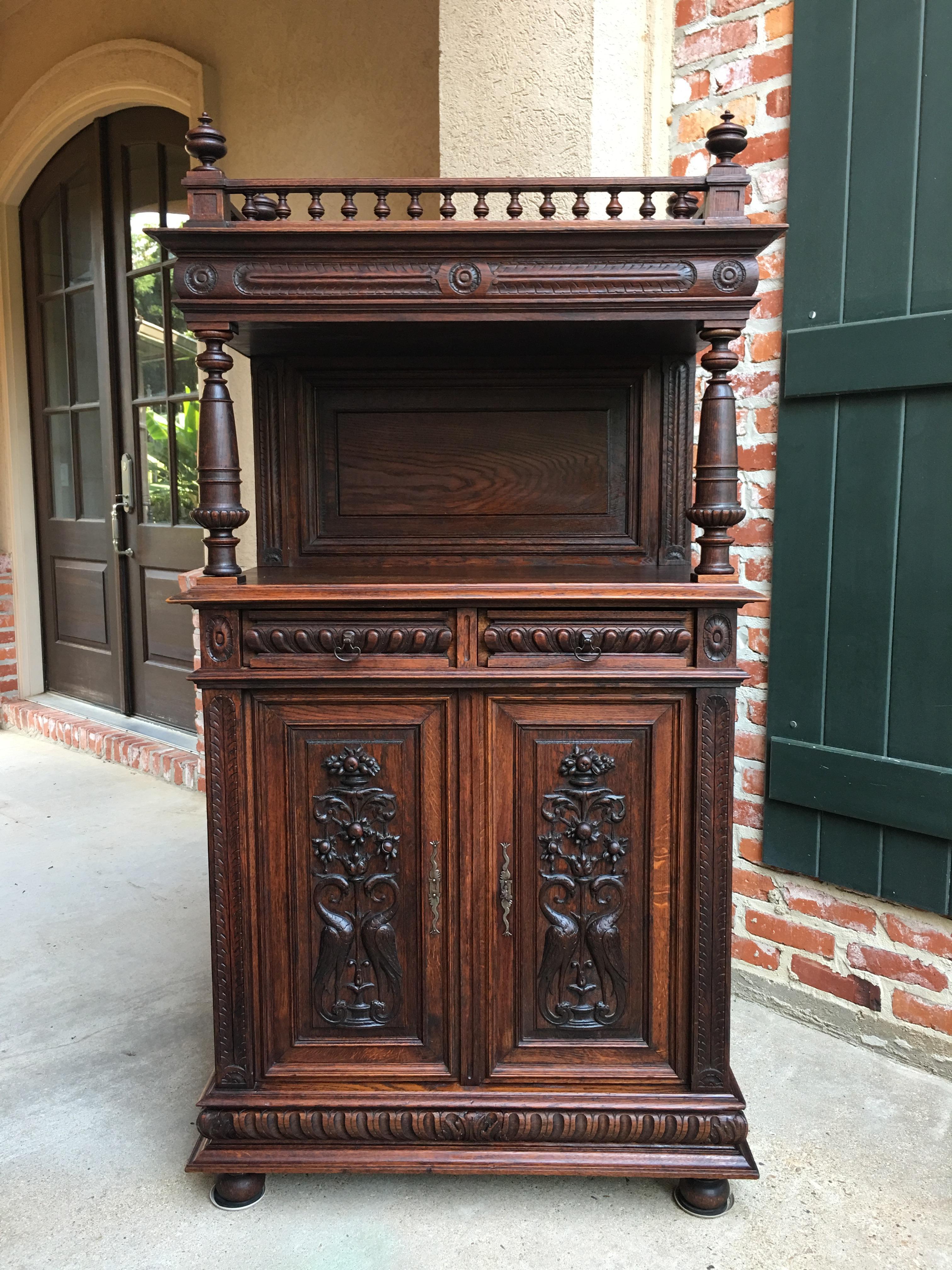 Direct from France, another unique antique carved oak French cabinet with outstanding features and a stunning silhouette~
~Carvings and trim from top to bottom, just look at the spindle top crown and those large corner finials!~
~Upper plateau has