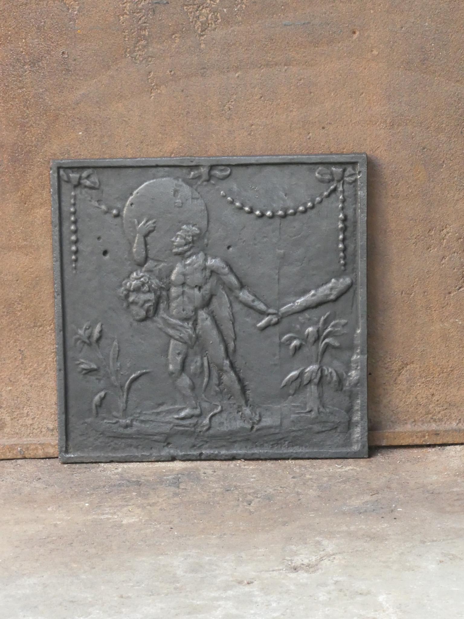 Late 18th or early 19th century French neoclassical period fireback. Hercules has Heaven in his arms, in exchange for the golden apples that Atlas promises to deliver.

The fireback is made of cast iron and has black / pewter patina. The fireback is