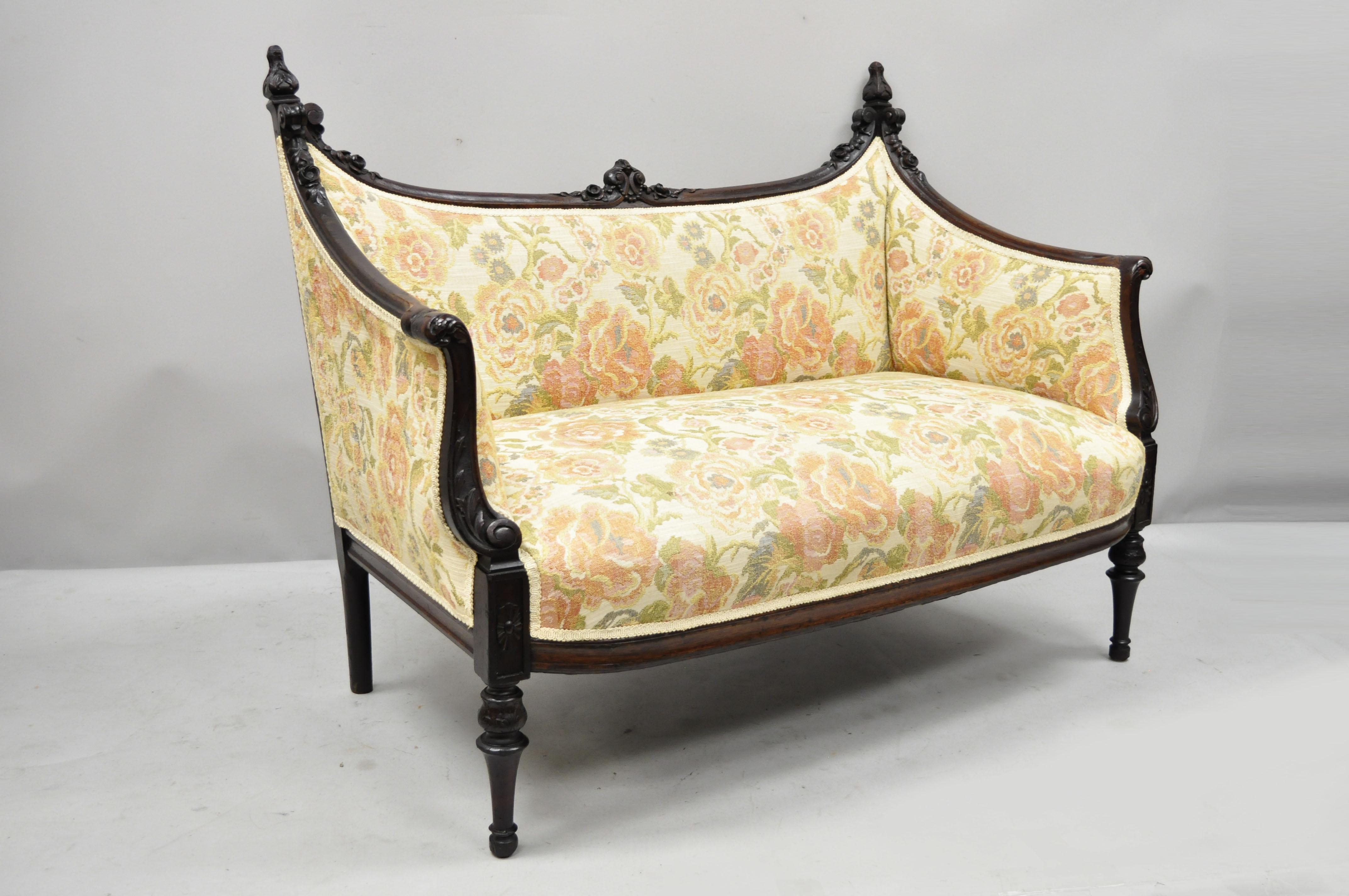 Small Antique French Louis XVI style carved mahogany Victorian settee. Item features unique shapely frame, floral carved details, acanthus carved finials, tapered legs, very nice antique item, circa 1900. Measurements: 34