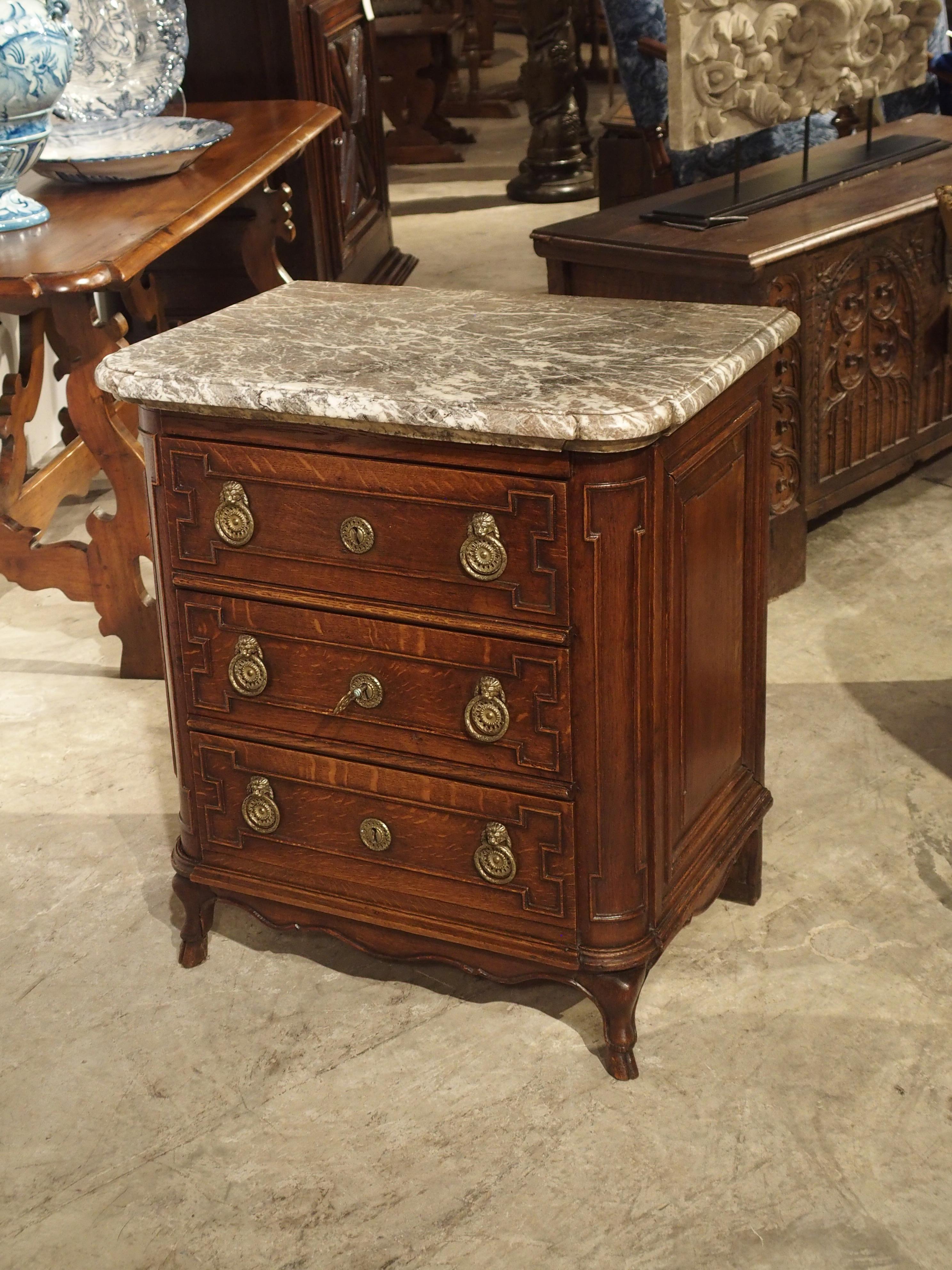 From circa 1770, this small French oak commode with marble top is in great condition. The marble top is quite thick at two inches, which means this chest of drawers can be used in the bedroom as a night table or in the bathroom with a small sink on