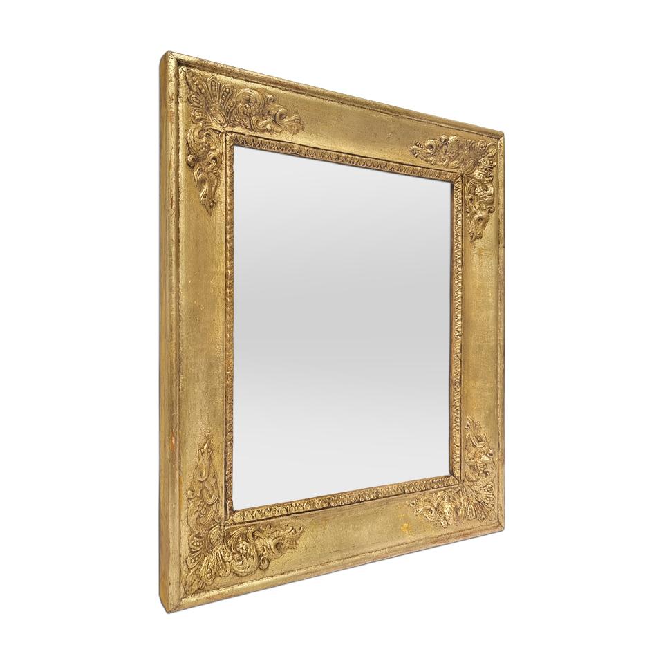 Small French antique “Restauration” style wall mirror, circa 1890. Wood and gilded stucco frame decorated with rais-de-coeur and palmettes in the corners. Antique frame re-gilding patinated with leaf. Frame width: 5.5 cm / 2.16 in. Modern glass