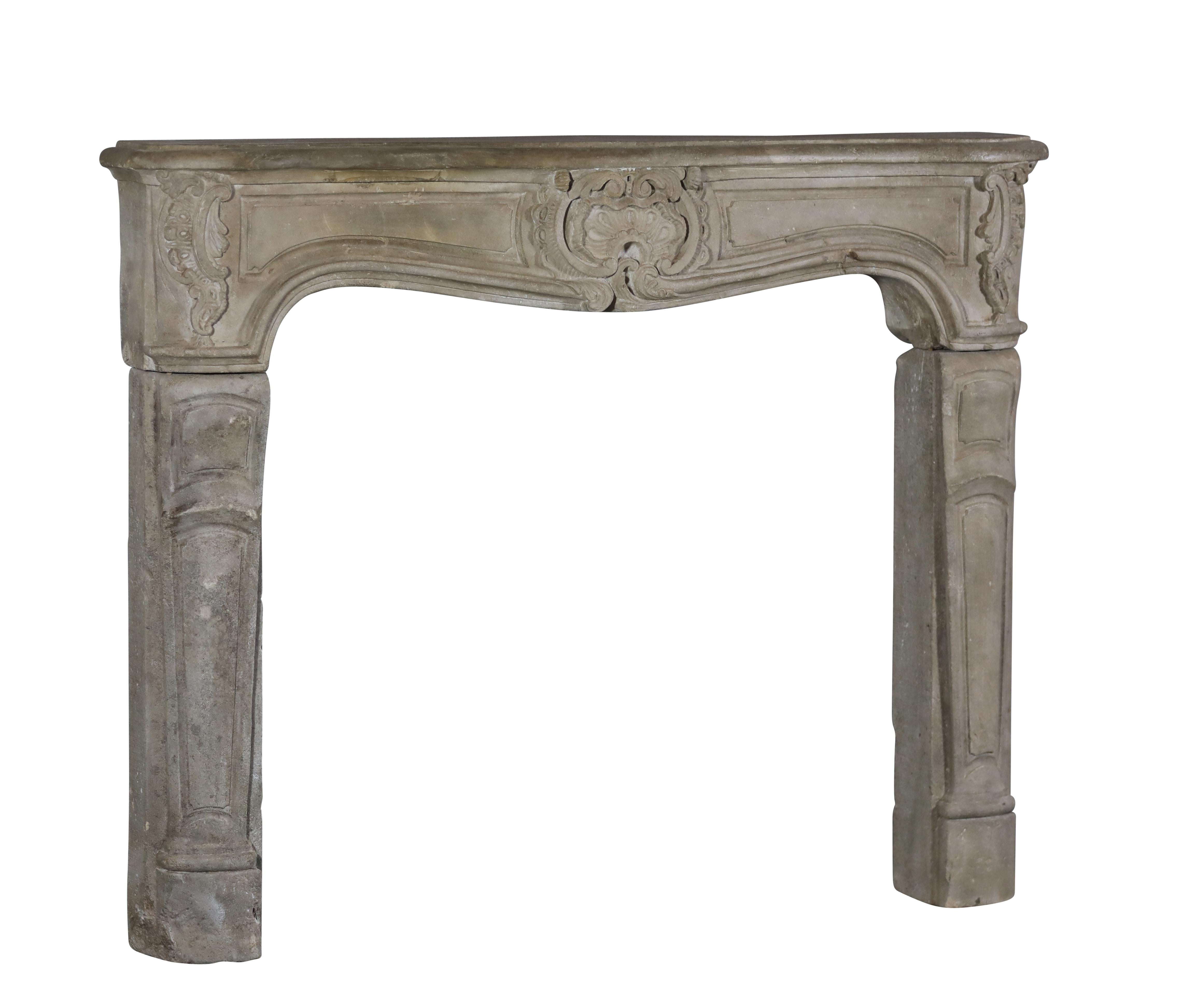 A French country, rustic, original antique fireplace surround in grez limestone. It is restored on the front of the shelf. This chimney piece is of the Regency period, 18th century. A perfect petite fireplace mantle with a lot of