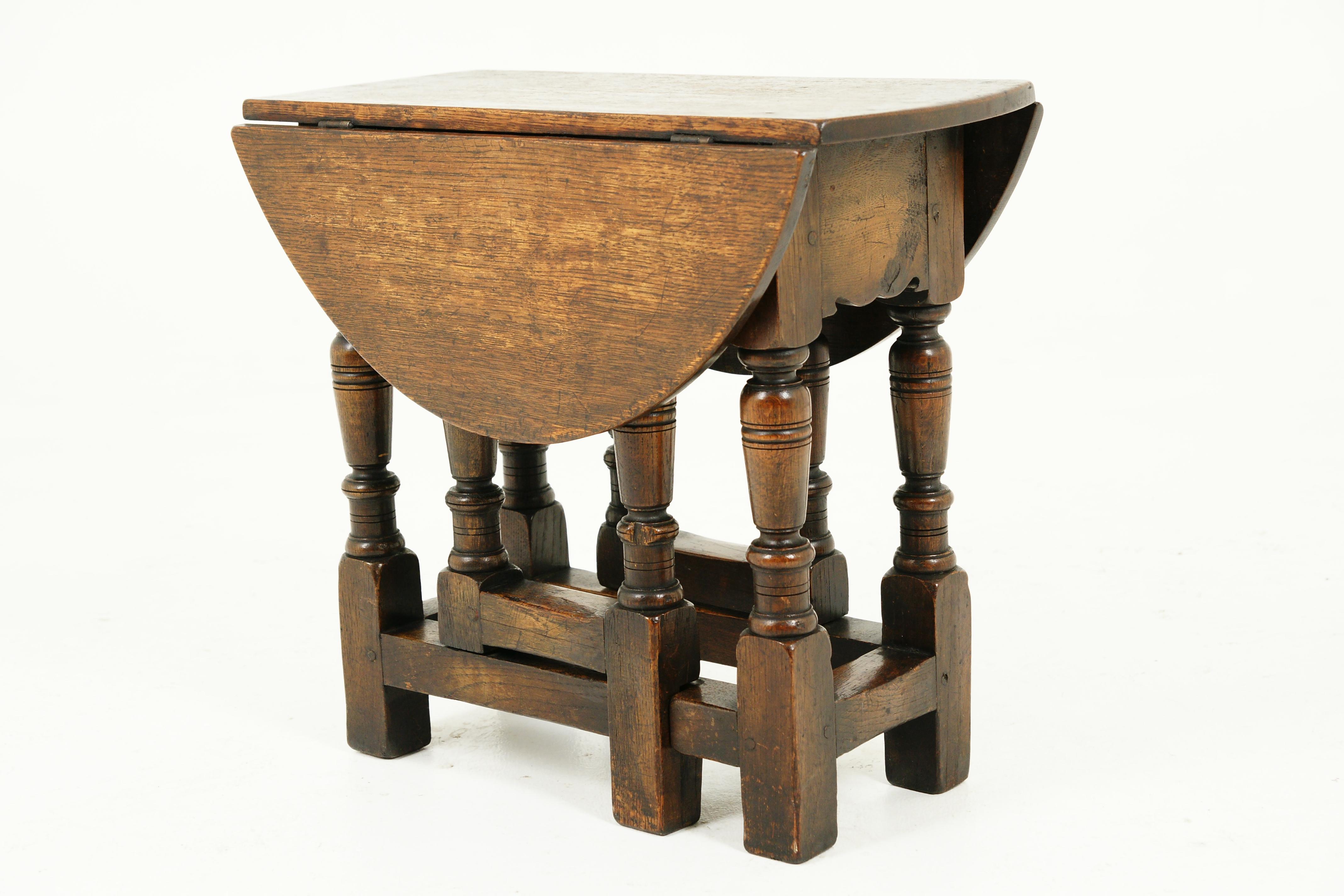 Small antique gateleg table, oak drop leaf table, Scotland 1920, B2389

Scotland 1920
Solid oak
Original finish
Rectangular solid oak top
Pair of half moon leaves on the sides
All standing on thick turned legs connected by stretchers
Note