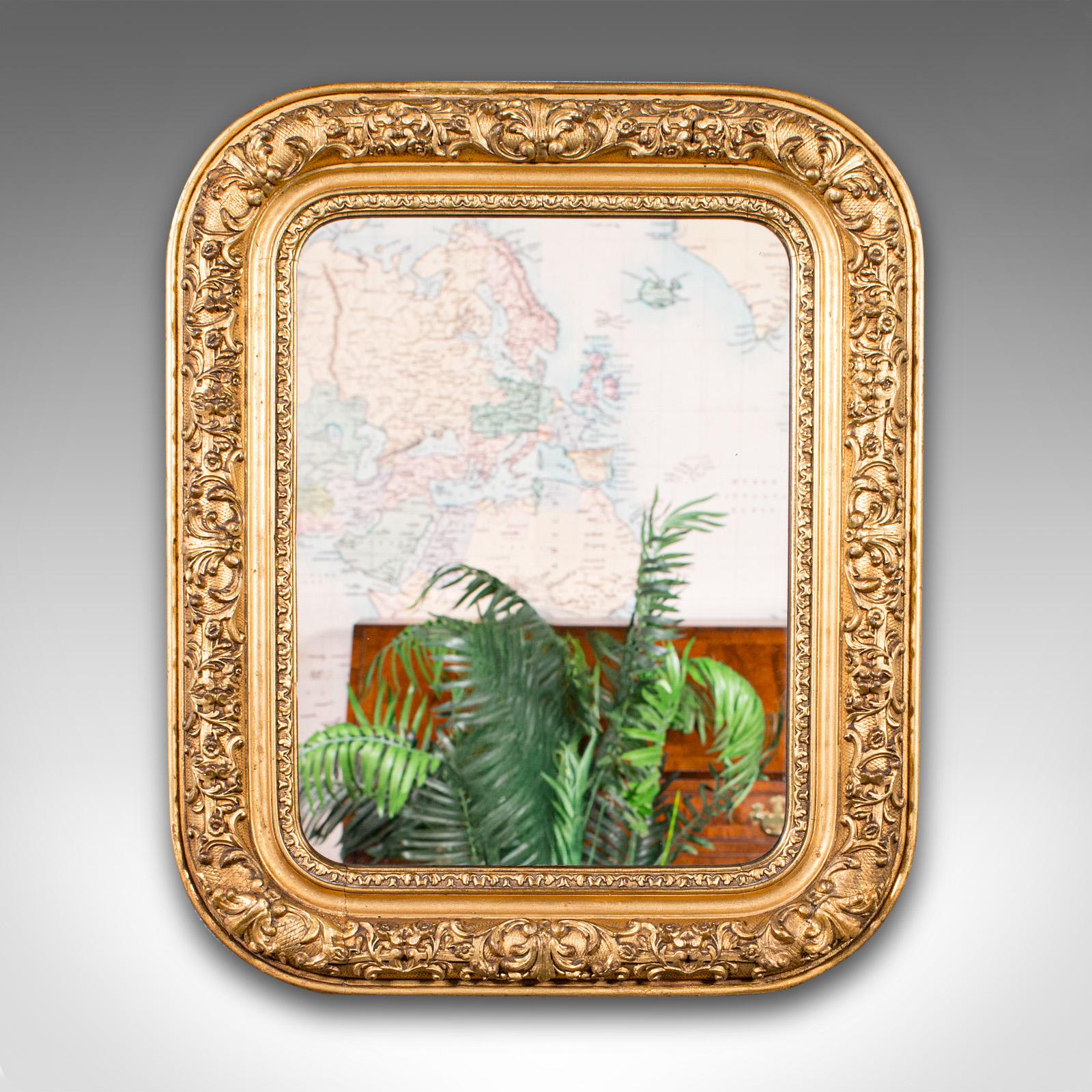 This is a small antique hall mirror. An English, gilt gesso vanity wall mirror, dating to the Georgian period, circa 1800.

Petite and ornate, with a delightful appearance
Displays a desirable aged patina and in good order
Quality golden hues to the