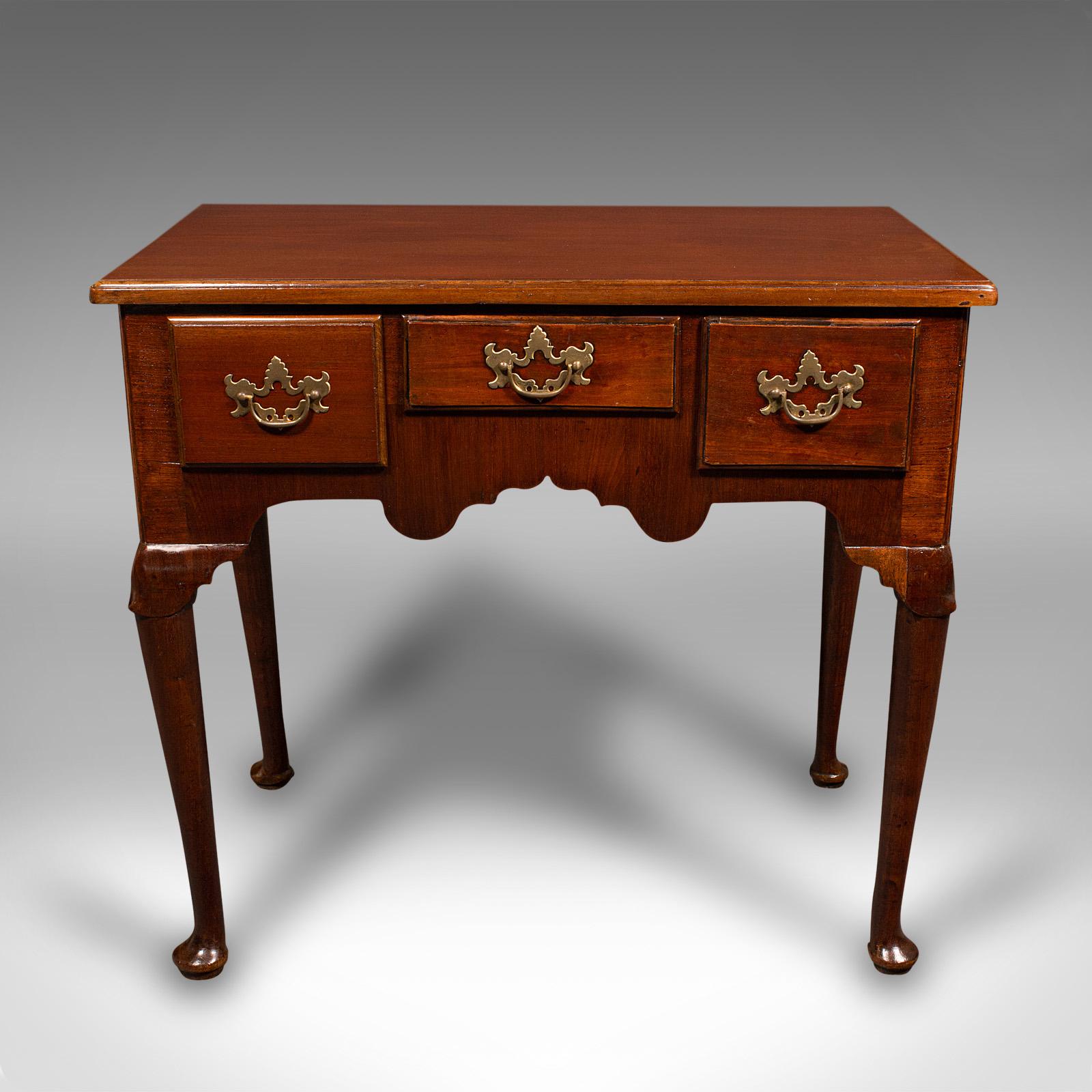 This is a small antique hall table. An English, mahogany and oak lowboy, dating to the Georgian period, circa 1780.

Appealing proportion and fine craftsmanship
Displaying a desirable aged patina and in good order
Select stocks offer fine grain