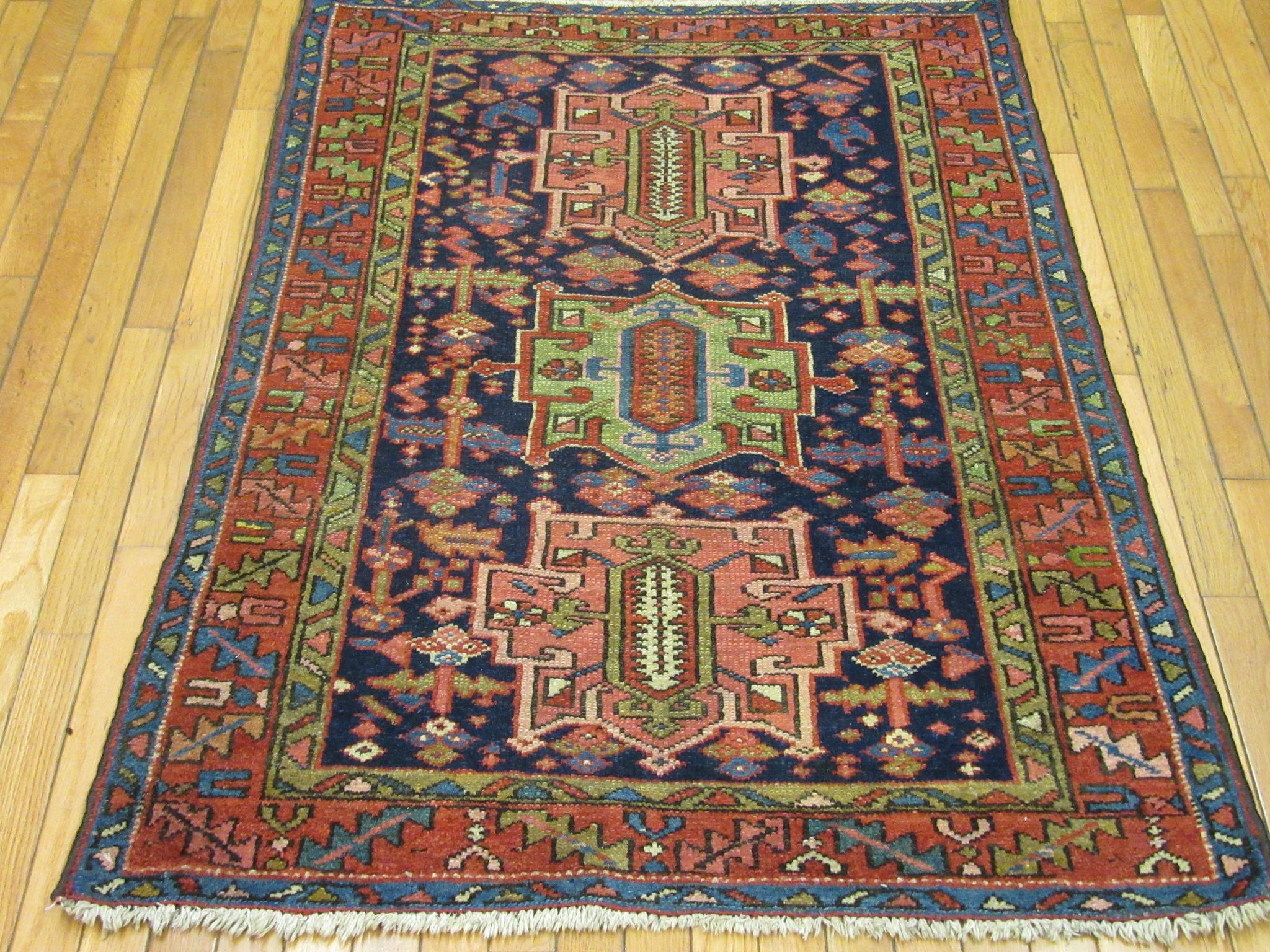This is a small hand-knotted antique Persian Heriz rug. It is made with wool pile and cotton foundation and natural dyes in a geometric multi medallion design. It a perfect rug for any spot in your house or office. It measures 
3'5