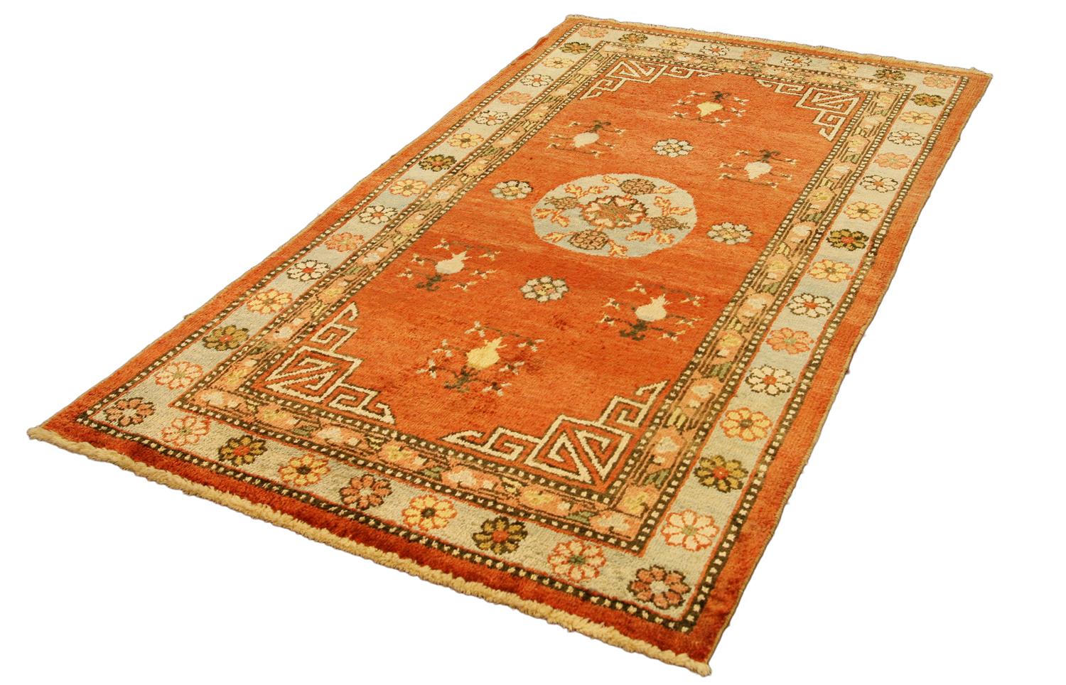 This is a silk antique Khotan from East Turkestan seamlessly woven circa 1920. This brilliant silk Khotan undoubtedly has an extraordinary floral design and a unique color palette of rust and red. Silk Khotan rugs are extremely beautiful and highly