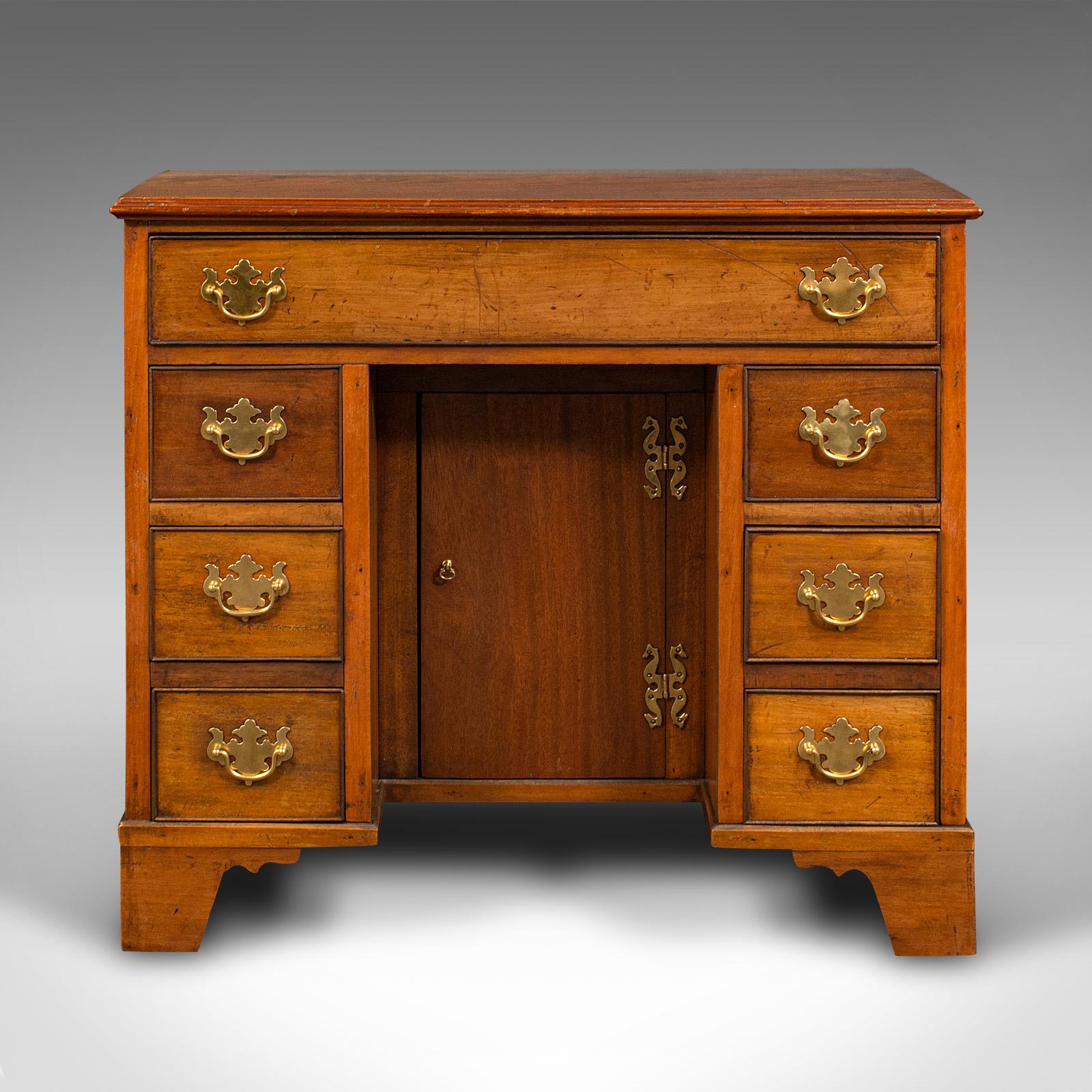 This is a small antique kneehole desk. An English, mahogany writing table with Georgian revival taste, dating to the Edwardian period, circa 1910.

Delightfully petite decorative desk, ideal for the vestibule.
Displaying a desirable aged patina