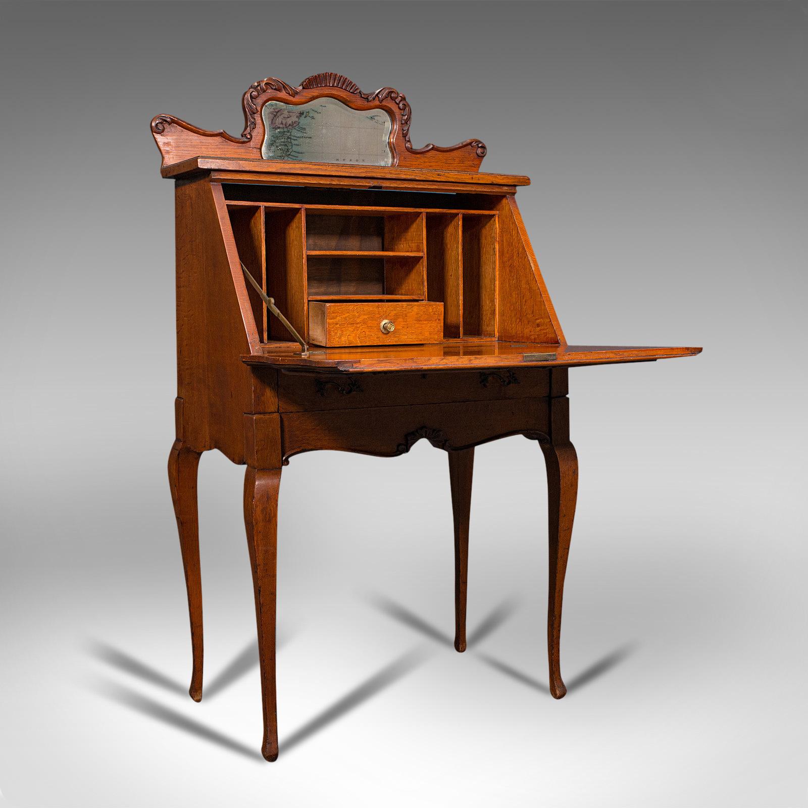 This is a small antique ladies writing desk. A French, oak bureau with mirror, dating to the Victorian period, circa 1900.

Of wonderful proportion and rich in colour
Displaying a desirable aged patina and in good order
Delightful light French