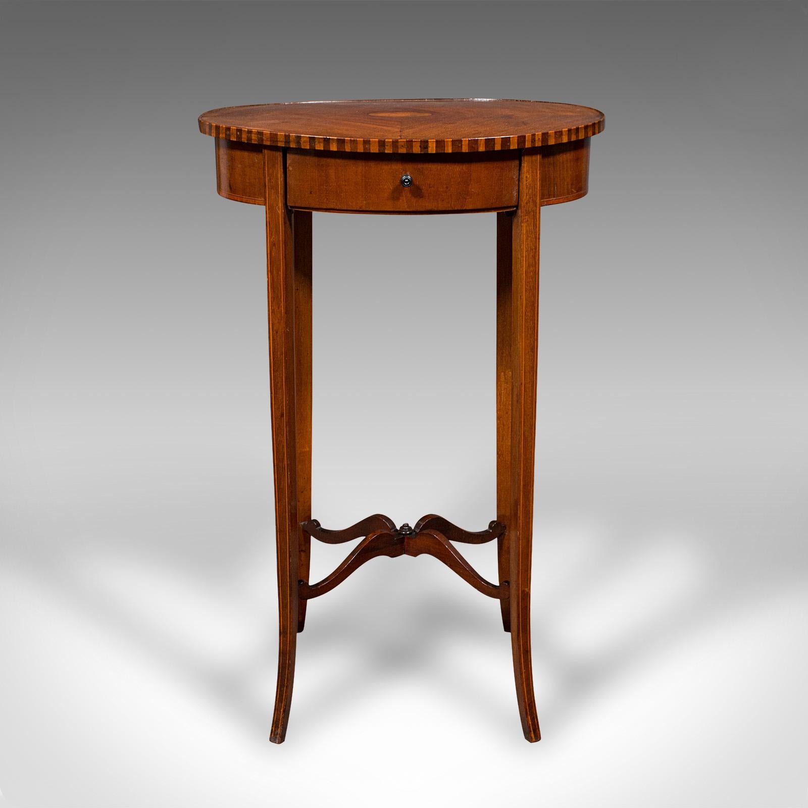This is a small antique lamp table. An English, mahogany oval side table in Regency Revival taste, dating to the Edwardian period, circa 1910.
 
Presenting Regency overtones in a delightfully petite oval form
Displays a desirable aged patina and