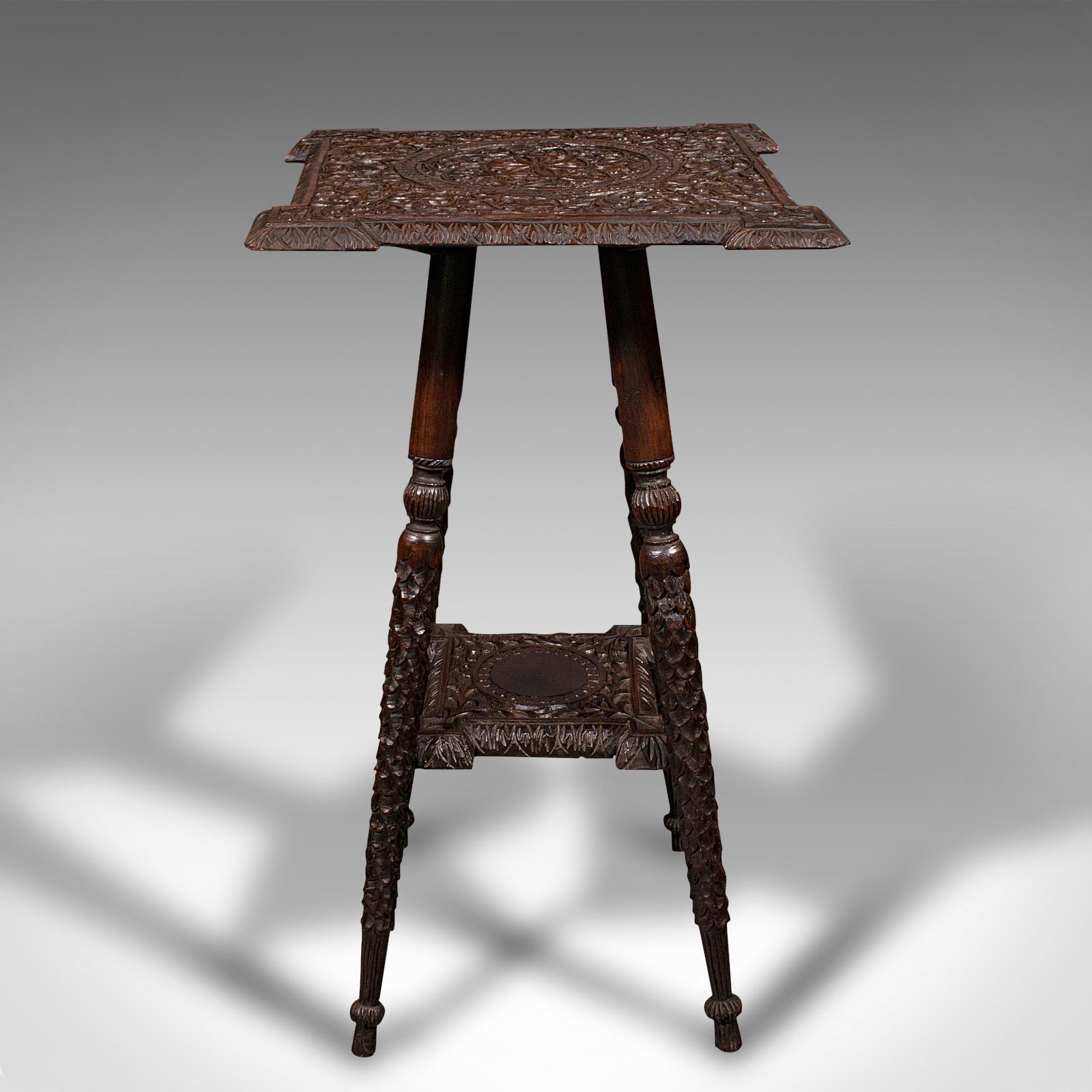 This is a small antique lamp table. An Indian, carved teak decorative occasional table, dating to the early Victorian period, circa 1850.

Of petite form and appealing carved finish
Displays a desirable aged patina and in good original