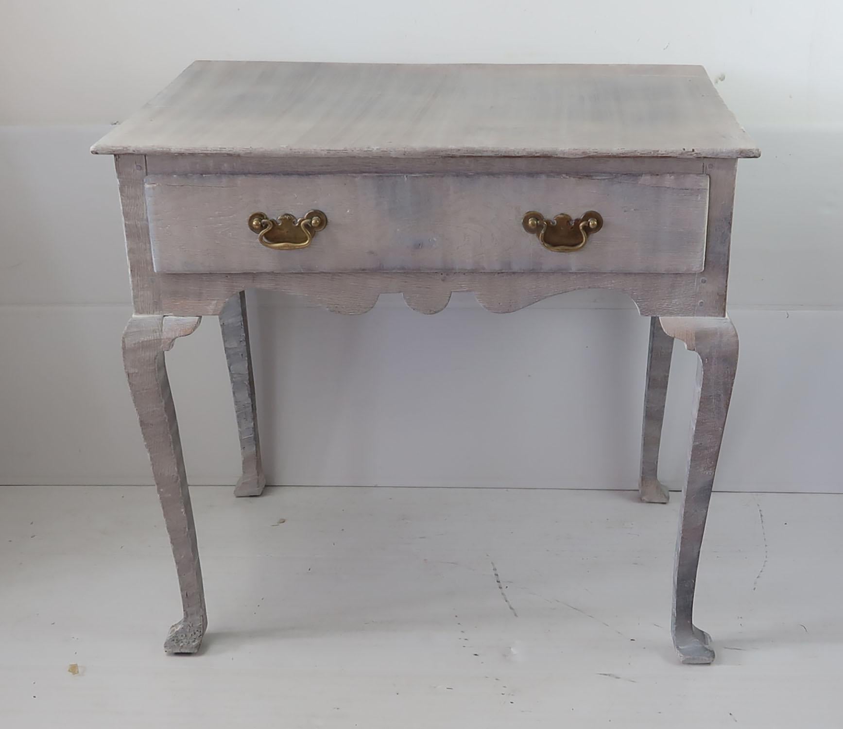 Small George I limed oak lowboy

I particularly like the simplicity of this table.

Recently limed to enhance the beautiful grain in the oak

Original brass hardware to the drawer

There is some historical restoration work to the two back