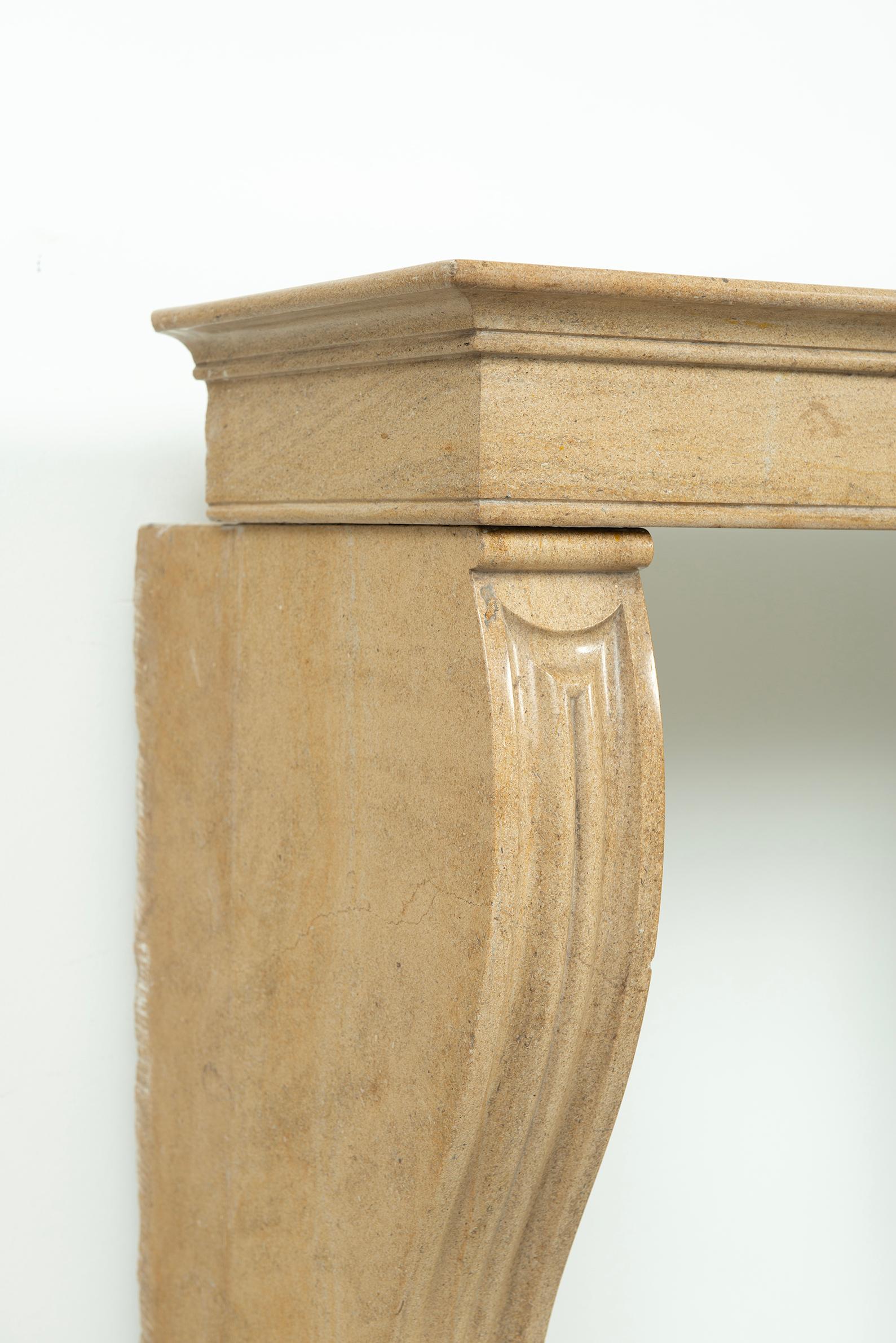 Nice French Campagnard style fireplace mantel in lovely limestone.
This gem comes from central France, burgundy area.
Its perfect little size make it possible to install this mantel in almost any situation, the two slender paneled legs support a