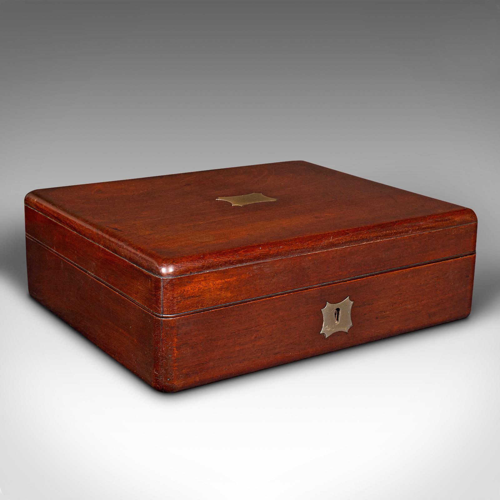 This is a small antique lined jewellery box. An English, mahogany and brass keepsake case, dating to the mid Victorian period, circa 1860.

Tastefully appointed jewellery box with traditional appeal
Displays a desirable aged patina and in good