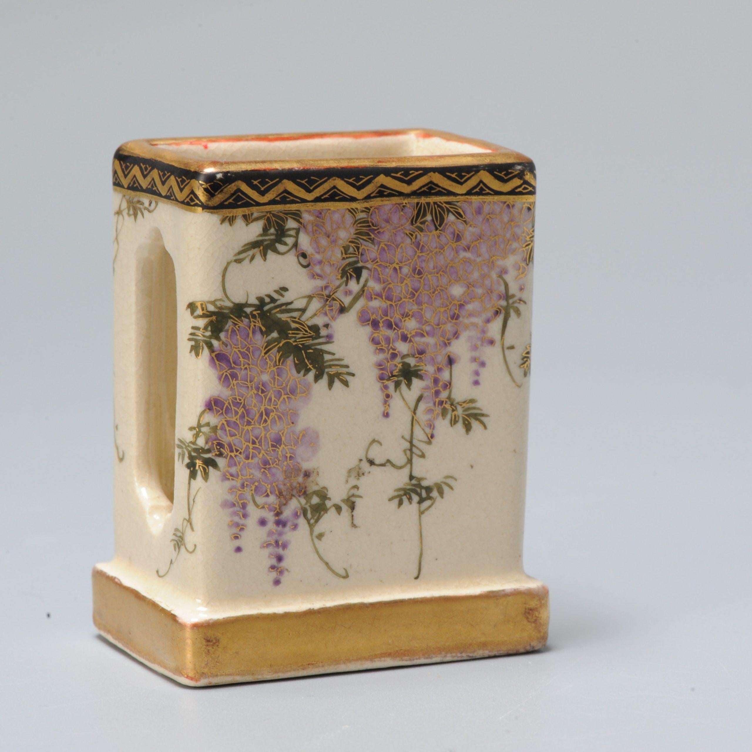 Fabulous and small japanese earthenware Satsuma Matchbox holder of great shape and scene.

The idea is to put the matchbox in it and then inside bit pushes open the matchbox and you strike the matchstick on the side.

Marked: Yasuda

Additional