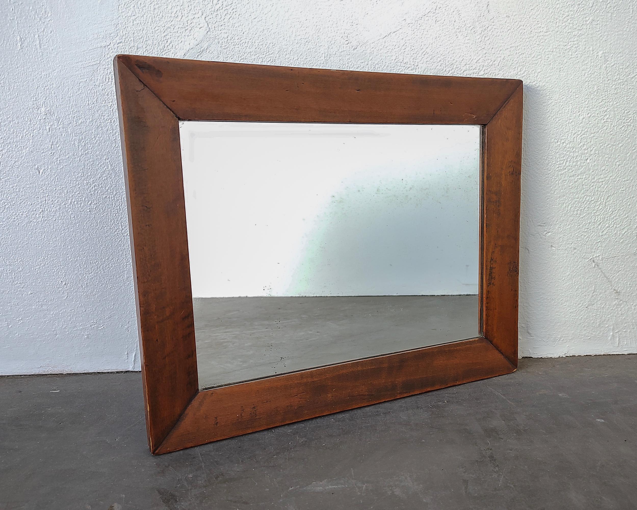 Antique mirror with a solid wood frame that has mitered joinery. Definite signs of age on the mirroring, some fogging and light corrosion spots. 

1