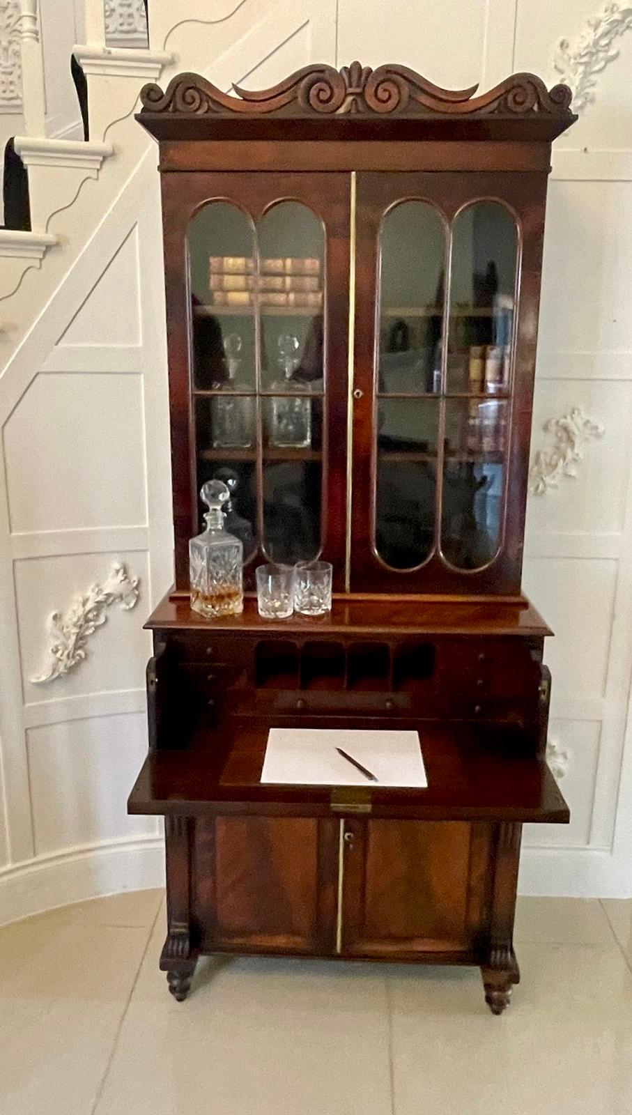 Small antique Regency quality figured mahogany secretaire bookcase having a quality carved mahogany cornice above a pair of unusual glazed moulded doors opening to reveal two adjustable shelves above a figured mahogany secretaire drawer with