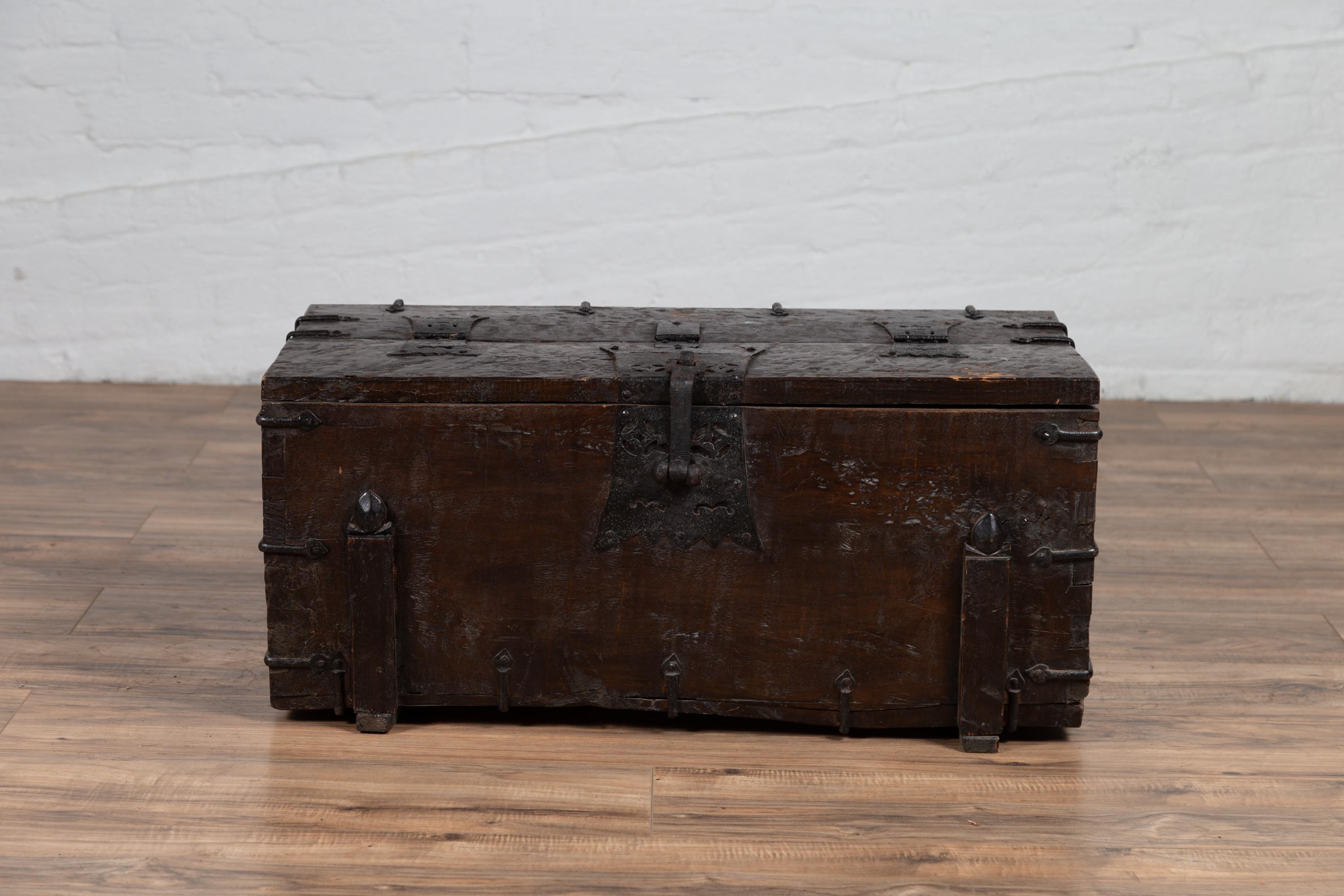 A small Korean antique wooden trunk from the early 20th century with metal hardware. Born in Korean during the early years of the 20th century, this small rustic wooden trunk features a rectangular partially folding lid, that opens to reveal a