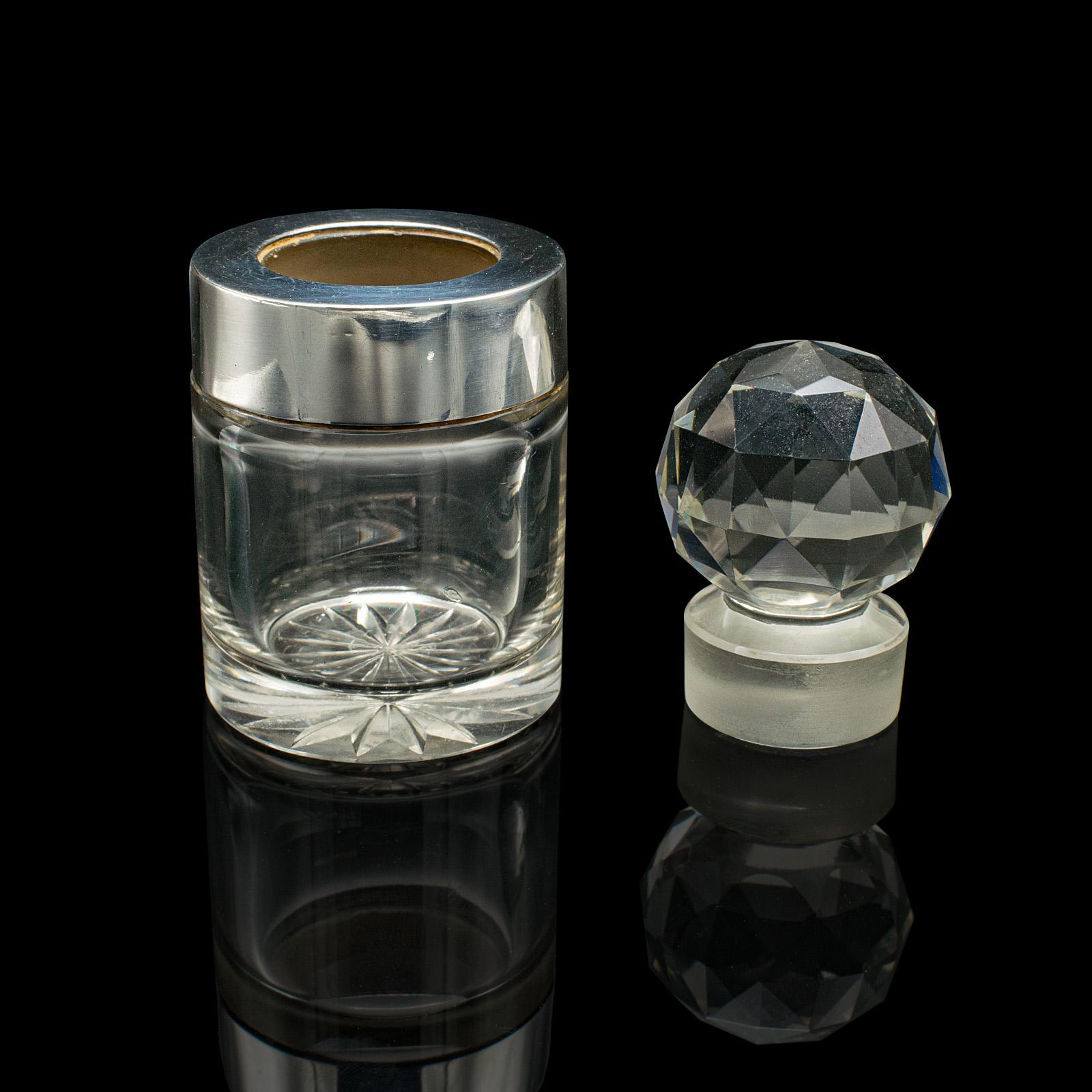 
This is a small antique scent bottle. An English, cut glass and hallmarked silver perfume bottle, dating to the late Victorian period, circa 1900.

Appealing scent bottle, with a striking stopper and petite form
Displays a desirable aged patina and