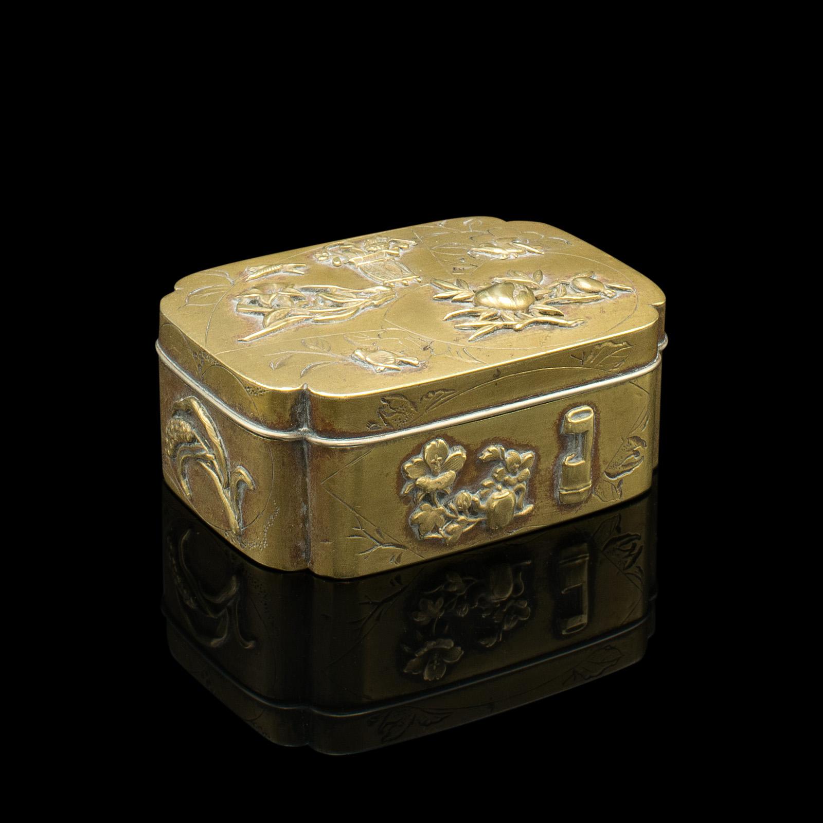 This is a small antique seamstress' button box. A Japanese, brass decorative tin, dating to the early Victorian period, circa 1850.

Delicately crafted box with wonderful colour and detail
Displays a desirable aged patina throughout with minimal