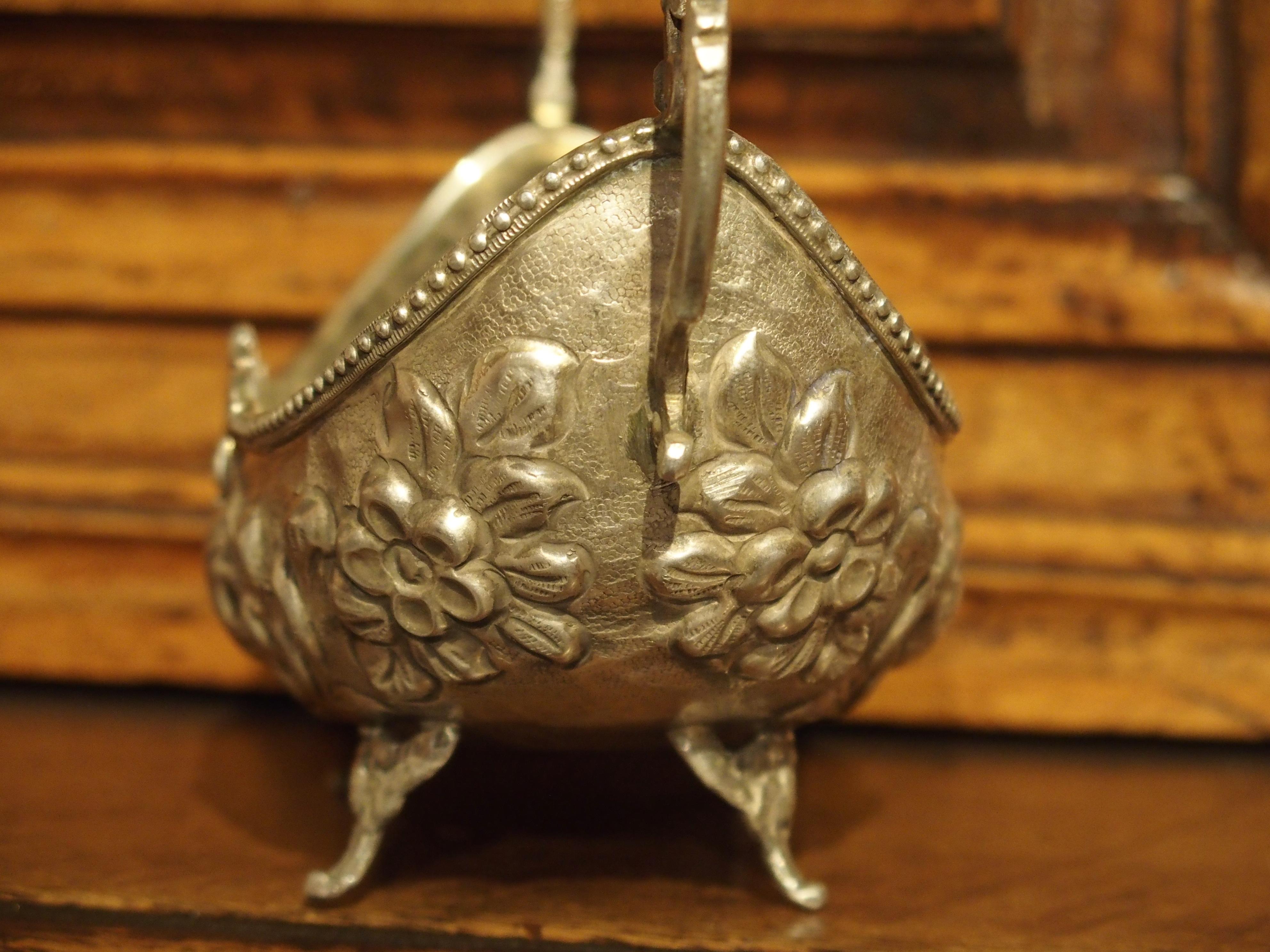 Approximate 270 grams.

This elegant small and detailed antique sterling silver bowl from Germany dates to the start of the 20th century. It has a gondola shape with demi figure arms of stylized dolphins and C-Scrolls at either end. Gadrooned