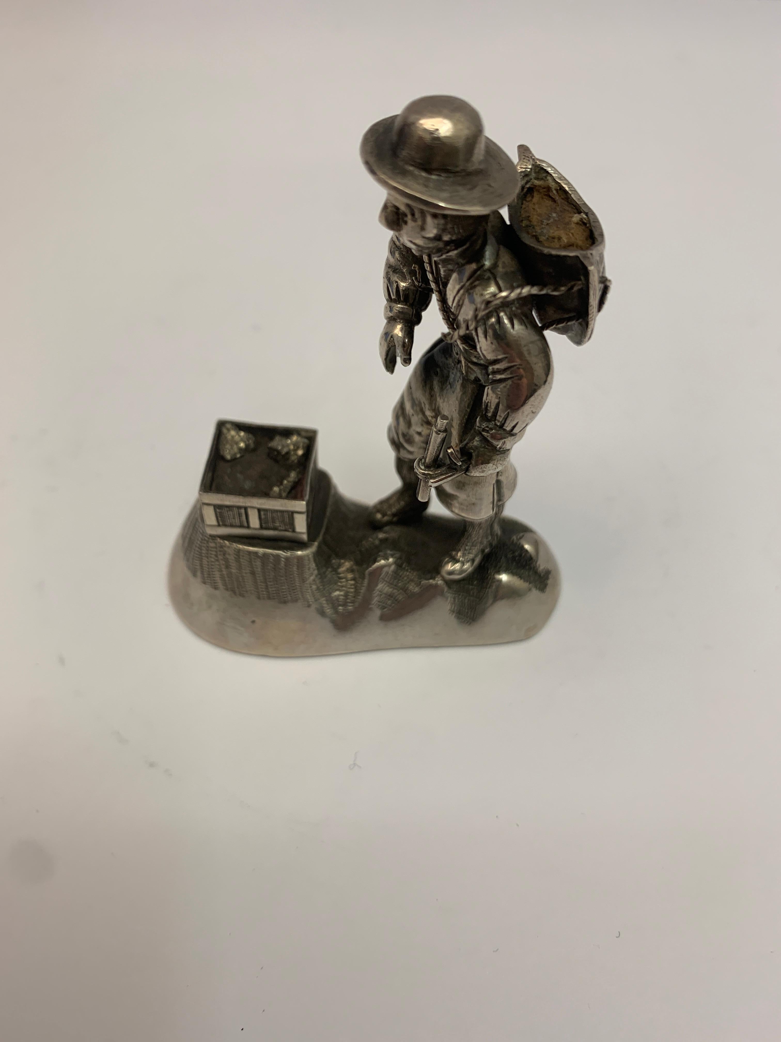 Small antique silver figural model of a prospector.