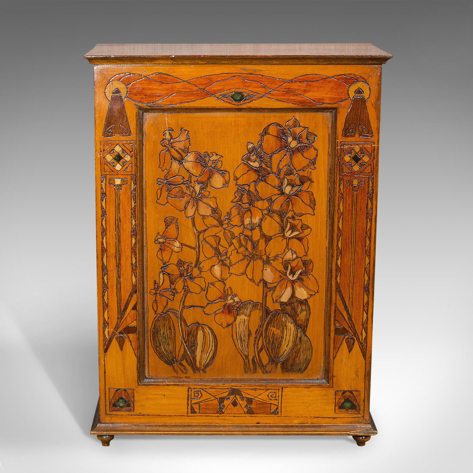 This is a small antique smoker's cabinet. An English, satinwood and pokerwork caddy in Art Nouveau taste, dating to the Victorian period, circa 1890.

Eye-catching storage for the gentleman smoker
Displaying a desirable aged patina
Satinwood