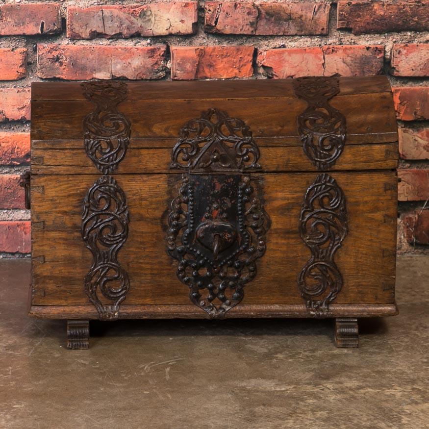 There is a tremendous amount of character packed into this small 18th century dome top oak chest. Take note of the wonderful handwrought iron work, the lock and handles that are all original. Boxes reinforced with this type of iron strap were often