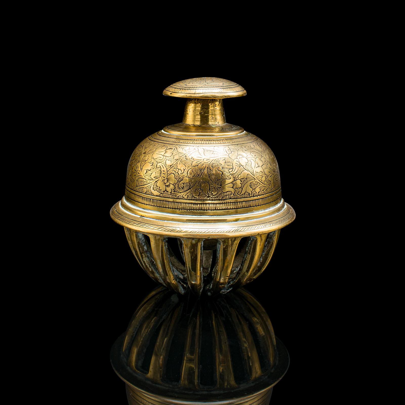 This is a small antique temple bell. An Oriental, brass tea calling chime, dating to the early 20th century, circa 1920.

An appealing small bell with a charming ring
Displaying a desirable aged patina throughout
Brass presents bright golden