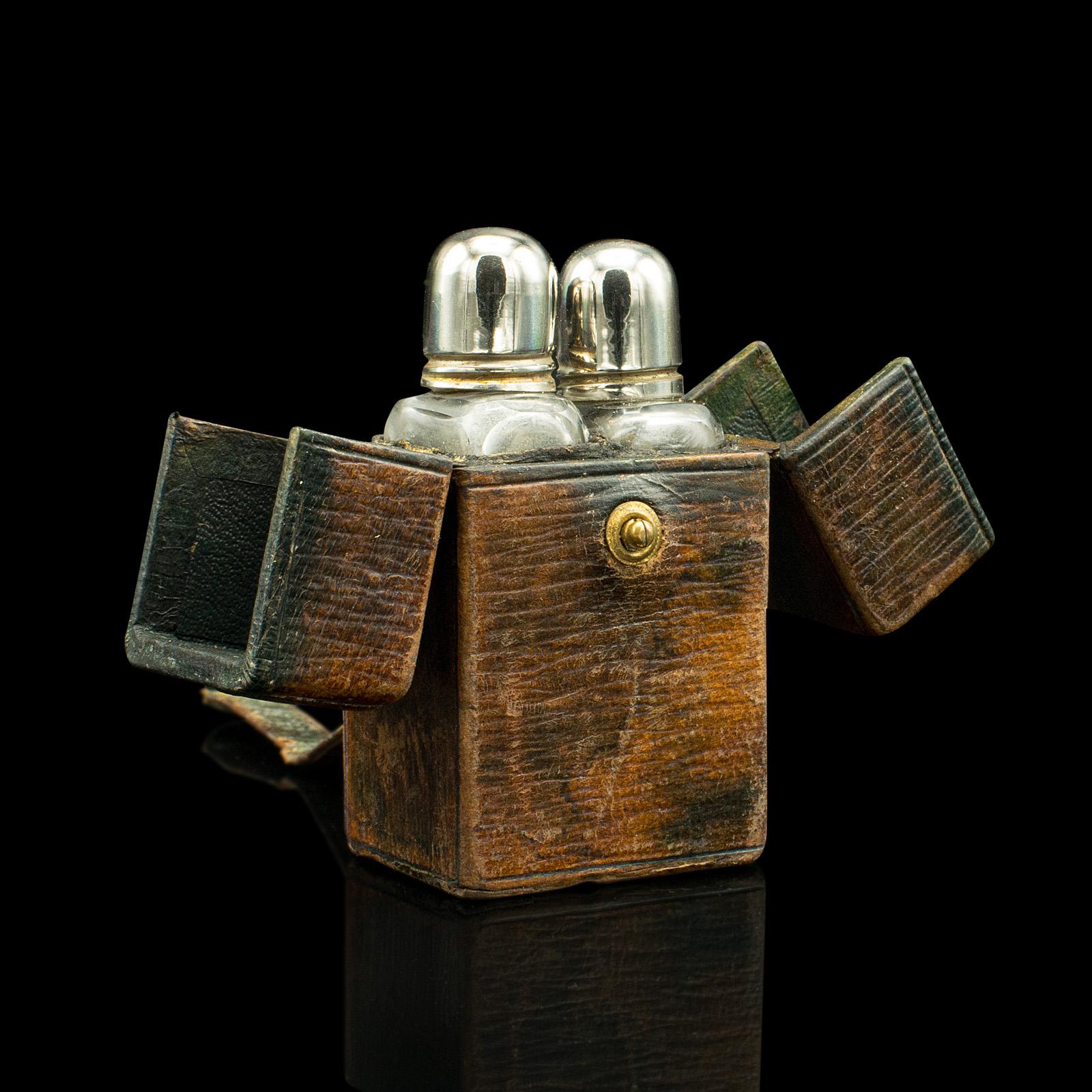 This is a small antique travelling perfume case. An English, leather and glass bottle holder, in the manner of Asprey, dating to the Victorian period, circa 1850.

Petite and charming, with an appealing time worn look
Displays a desirable aged