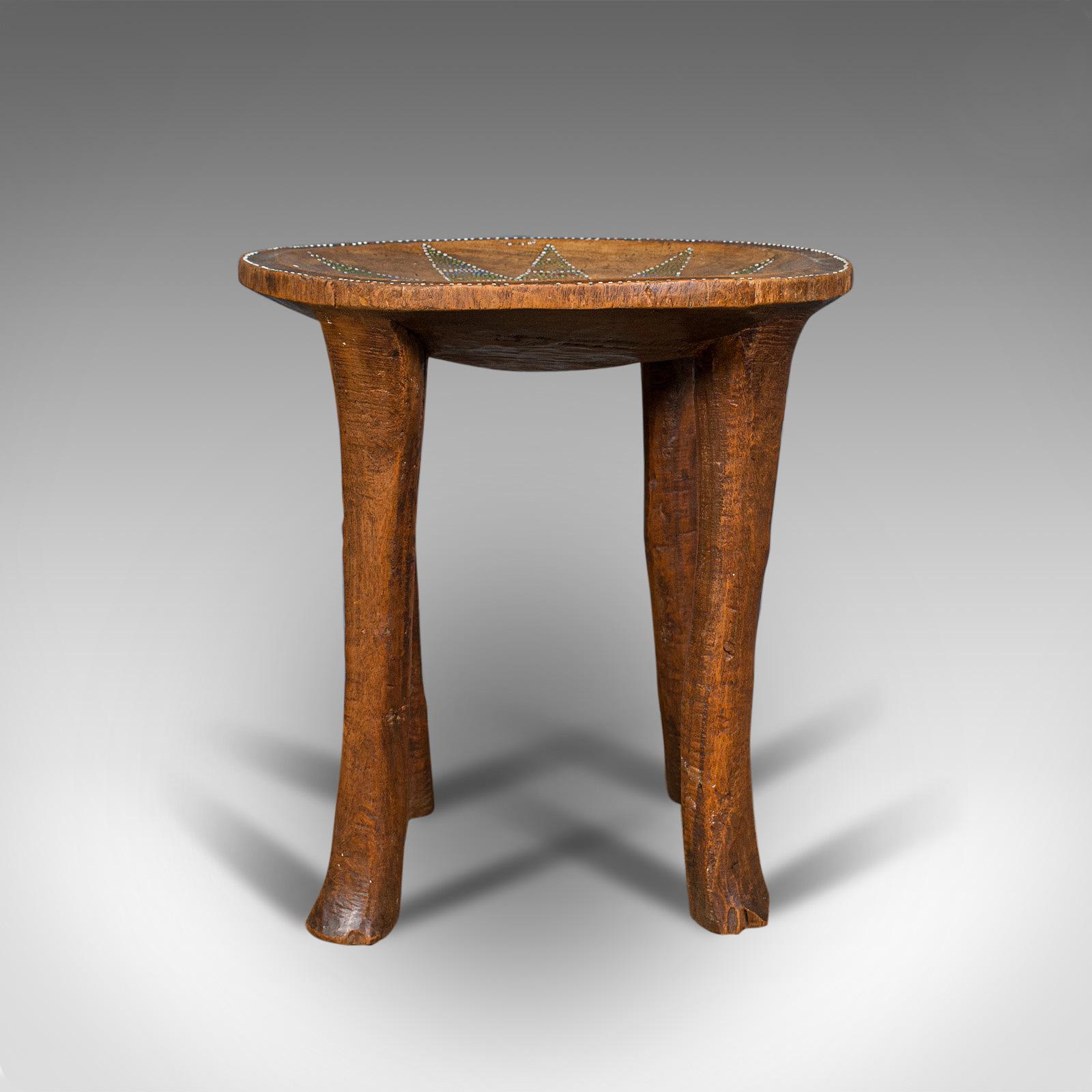 This is a small antique tribal side table. An Australian, fruitwood lamp table or stool, dating to the late Victorian period, circa 1900.

Naive indigenous charm and pleasingly decorated top
Displaying a desirable aged patina
Hand-carved