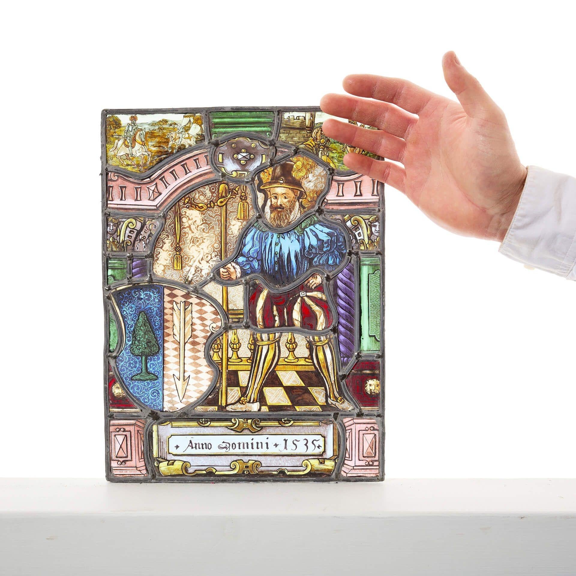 A small antique Tudor style stained glass window panel.
Although the panel displays the date ‘1535’ it was likely produced in the early 20th century, circa 1920.


The Latin words at the bottom translate to ‘in the year of the lord. 1535’ - the year