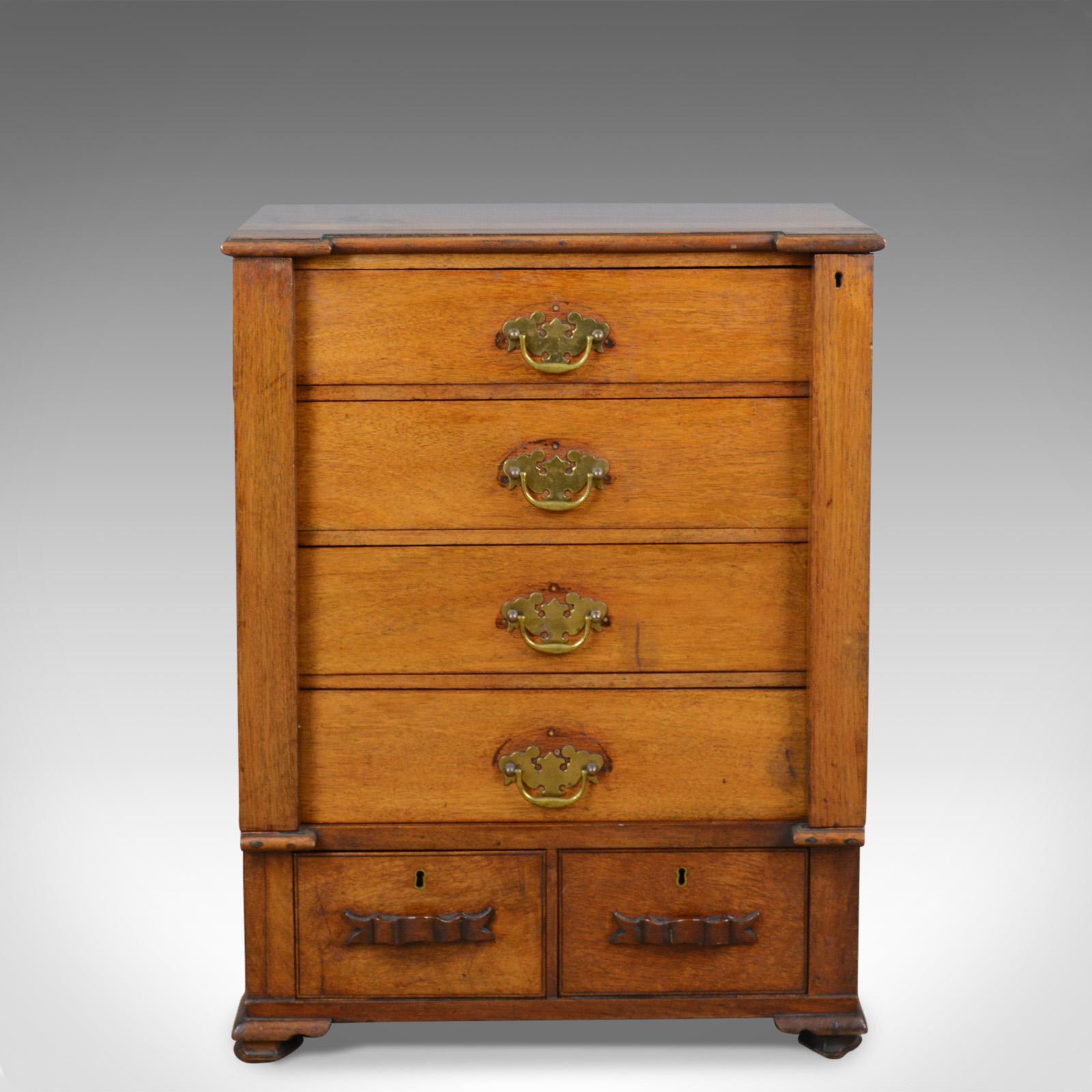 This is a small, antique Wellington chest. An English, oak and fruitwood, Campaign specimen chest of drawers dating to the late 19th century, circa 1890.

Delightful, small Wellington chest
Rich, warm hues to the oak and fruitwood
Grain