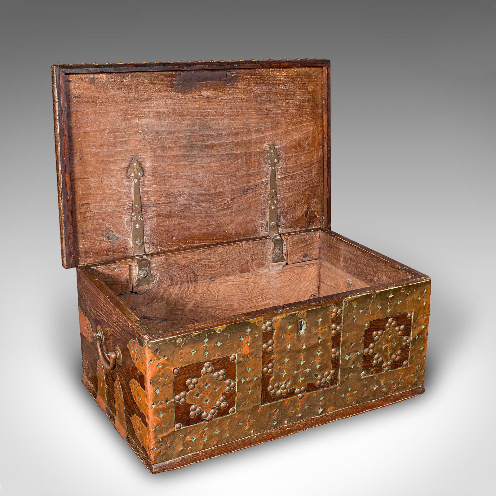 This is a small antique Zanzibar chest. An East African travel trunk in solid teak and brass, dating to the early Victorian period, circa 1850. A petite yet striking example, exhibiting quality craftsmanship and exotic appeal.

Fine East African