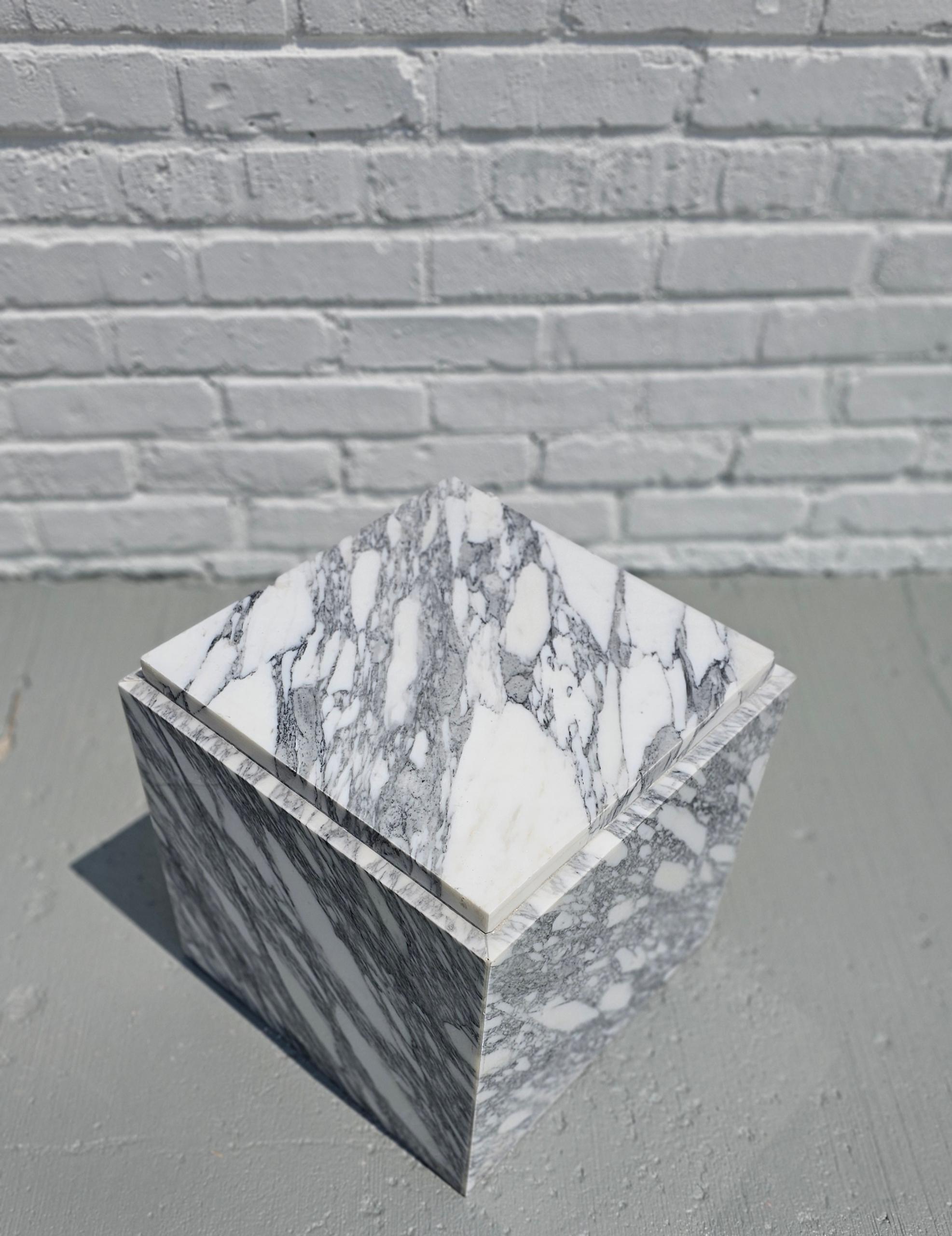 This cute little cube-shaped end table is made from beautiful Bianco Arabescato marble. This bright white marble features plenty of gorgeous veining throughout, in black, light grays and dark grays.  The veining flows over the top of the piece and