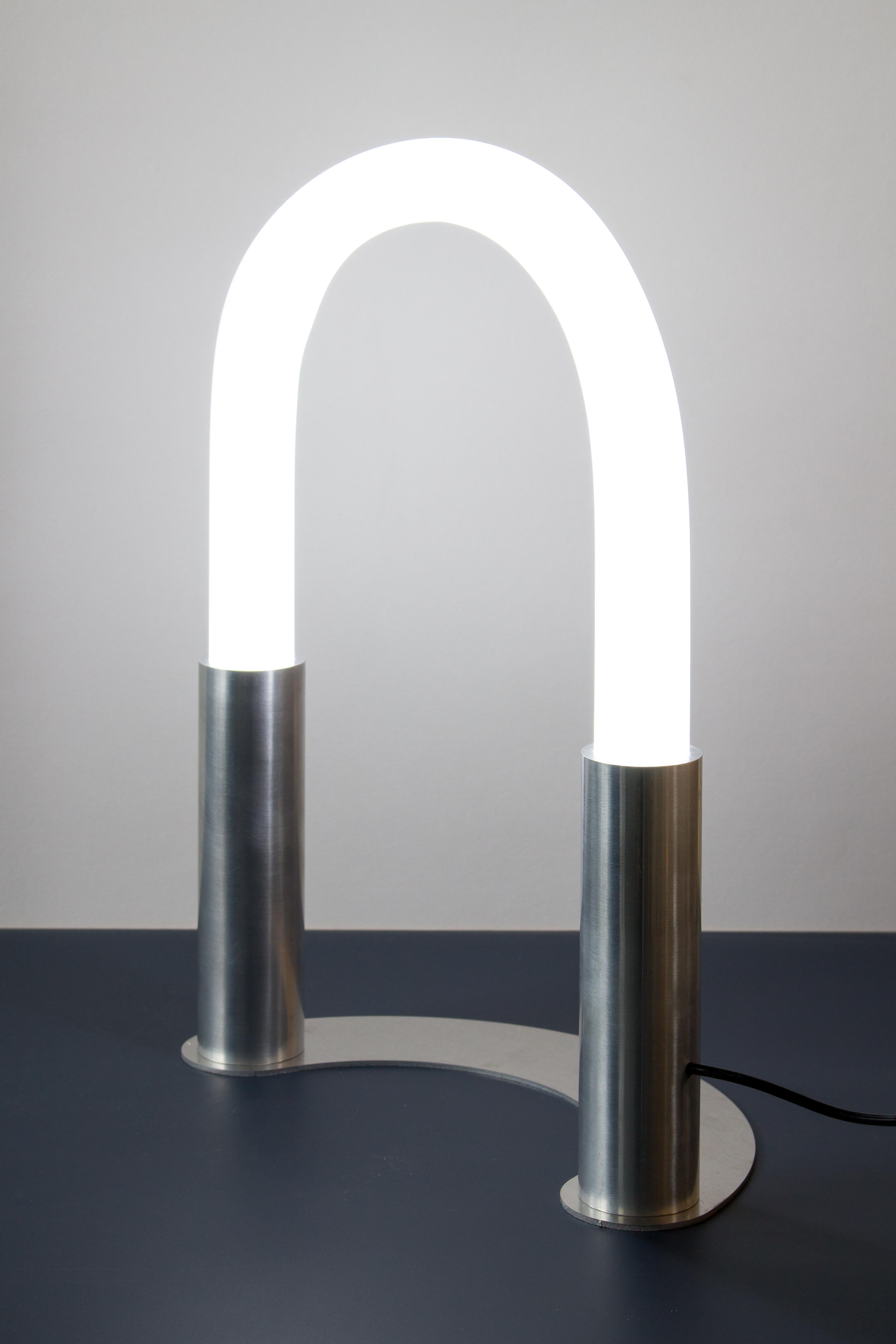Small Arceo table lamp by Joachim-Morineau Studio
Dimensions: H 30 x D 15 x W 35 cm, 2 kg
Materials: Aluminium beams, tubes and sheets, frosted plexiglass, warm light LED with dimmer.
Possibility to have a different colour/finish (such as blasted